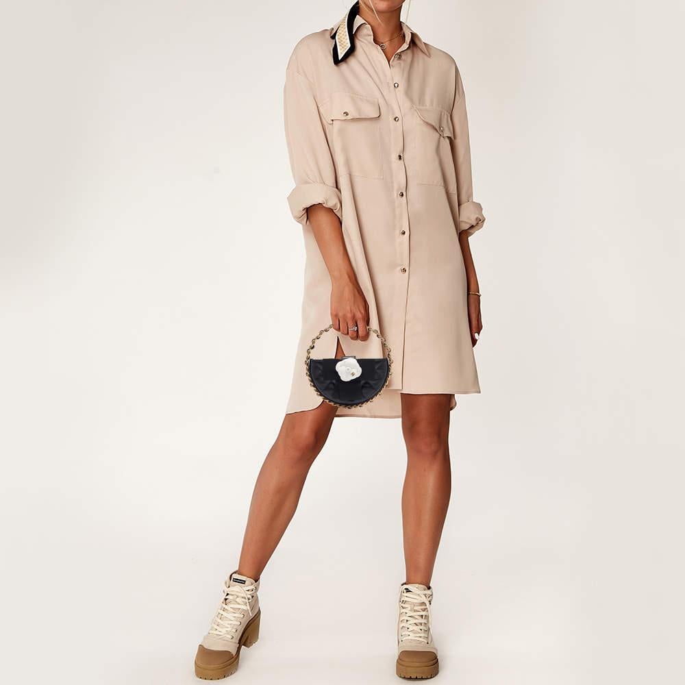 The Chanel clutch is a stunning accessory crafted from luxurious quilted leather. Its compact  round design features the iconic Camellia motif  offering a chic blend of classic style and modern flair. Ideal for any occasion  this clutch exudes
