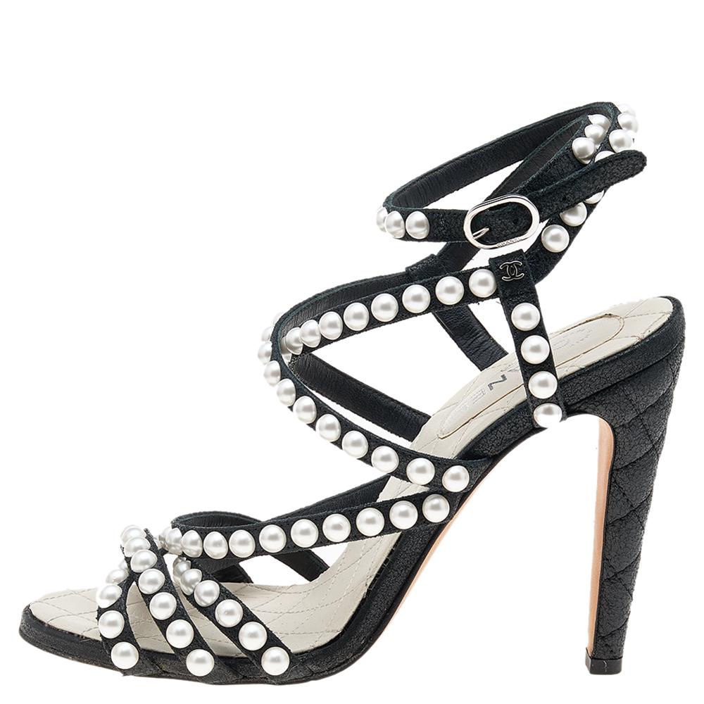 Chanel understands your need for comfort and style in these sandals. They have a statement look with pearl-embellished straps, open toes, ankle wraps, and 10.5 cm heels.

Includes: Original Dustbag