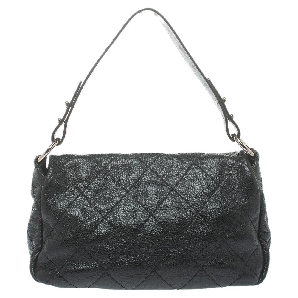 Unmistakably designed in Italy from Chanel’s signature quilted leather in a black hue, this On the Road flap bag presents a chic touch to one’s evening silhouette. Adorned with a flat shoulder strap, the outer flap is secured with a turn-lock
