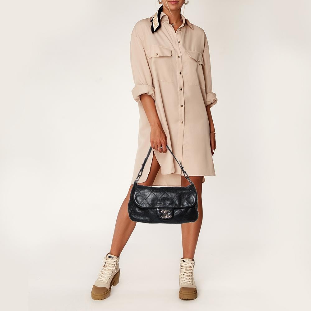 Designed in Italy from Chanel’s signature quilted leather in a black hue, this On the Road flap bag presents a chic touch to one’s silhouette. Adorned with a flat shoulder strap, the outer flap is secured with a CC turn-lock closure. The inside flap