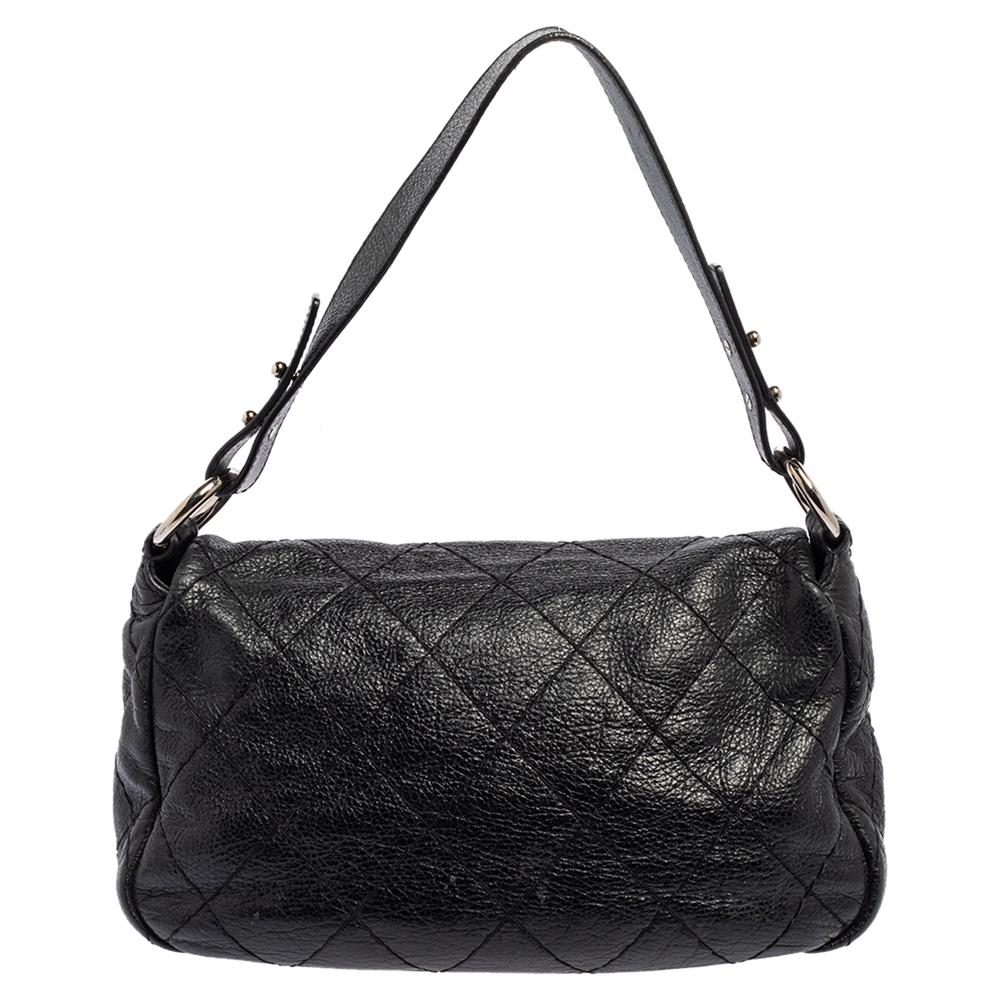 Designed in Italy from Chanel’s signature quilted leather in a black hue, this On the Road flap bag presents a chic touch to one’s silhouette. Adorned with a flat shoulder strap, the outer flap is secured with a CC turn-lock closure. The inside flap