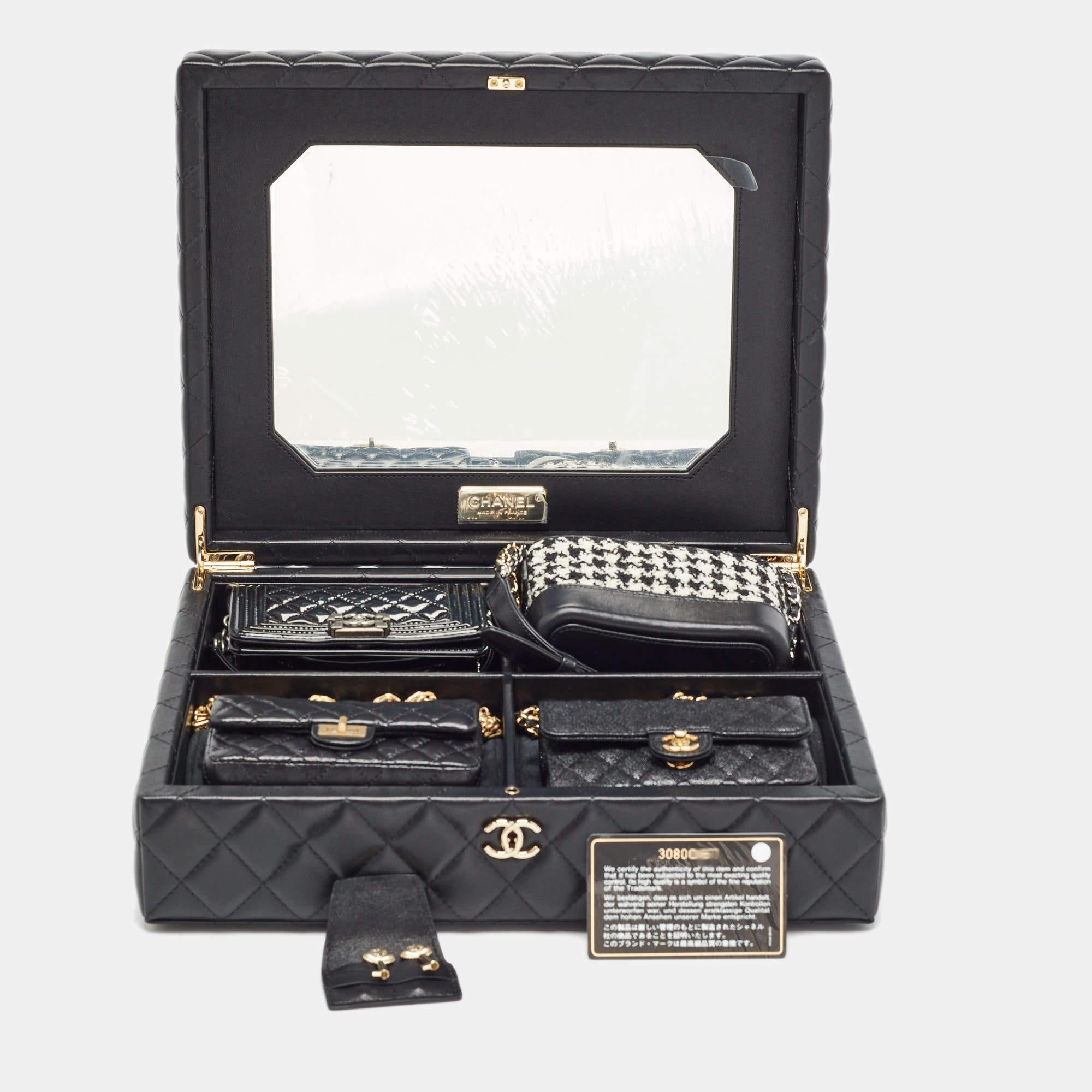 The Chanel Success Story Trunk set is a stunning collection in a diamond quilted box that includes four miniaturized icons of Chanel craftsmanship: the Caviar Classic Flap aged calfskin 2.55 Reissue Flap tweed Gabrielle Hobo and patent Boy Flap.