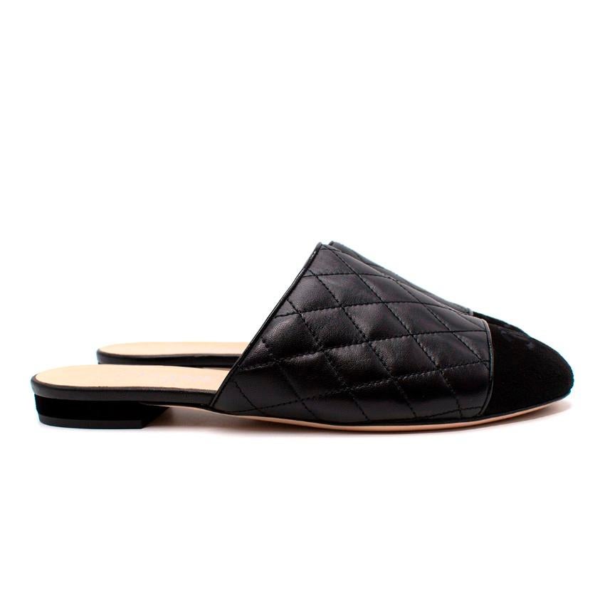 Chanel Black Quilted Leather Suede CC Logo Embroidered Toe-Cap Mules

- Signature contrasting toe-cap rendered in black suede with subtly embroidered CC logo
- Shoe upper crafted from smooth leather in diamond quilt
- Set on a suede low block heel
-