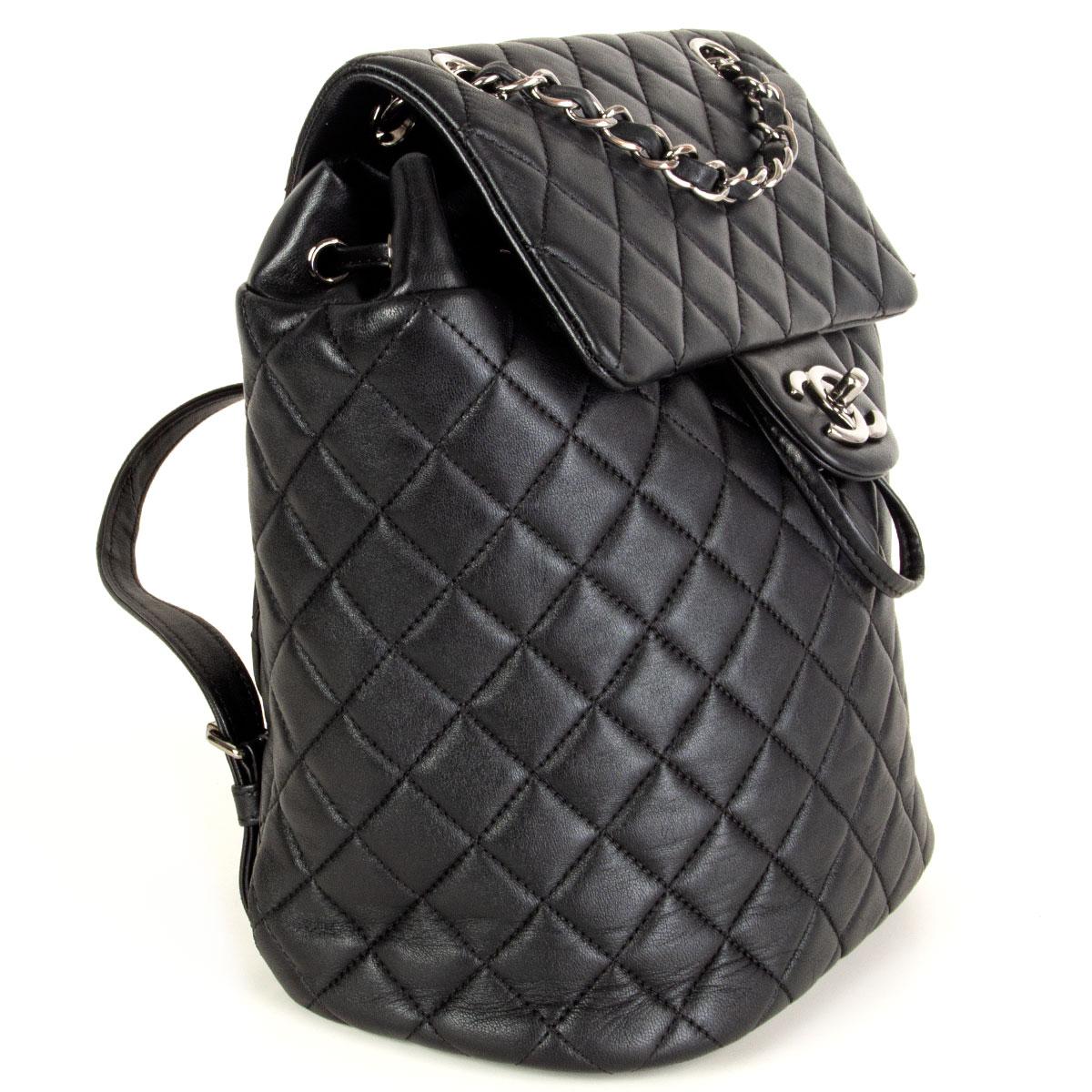 100% authentic Chanel Small Urban Spirit backpack in soft and smooth quilted black lambskin. It features polished dark silver-tone chain link leather threaded shoulder straps. Opens with a flap with a CC logo turn lock and leather drawstring to a