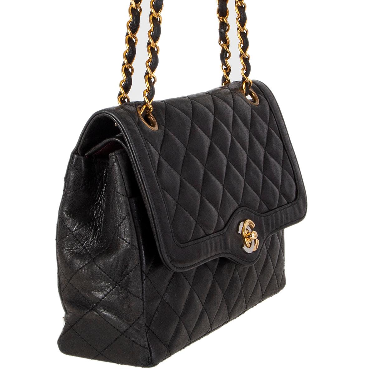 Chanel Vintage double flap shoulder bag in black quilted calfskin featuring gold- and silver-tone 'CC' turn lock. Outside pocket on the back and under the flap. Lined in burgundy calfskin with with tow open pocket and a lipstick pocket against the