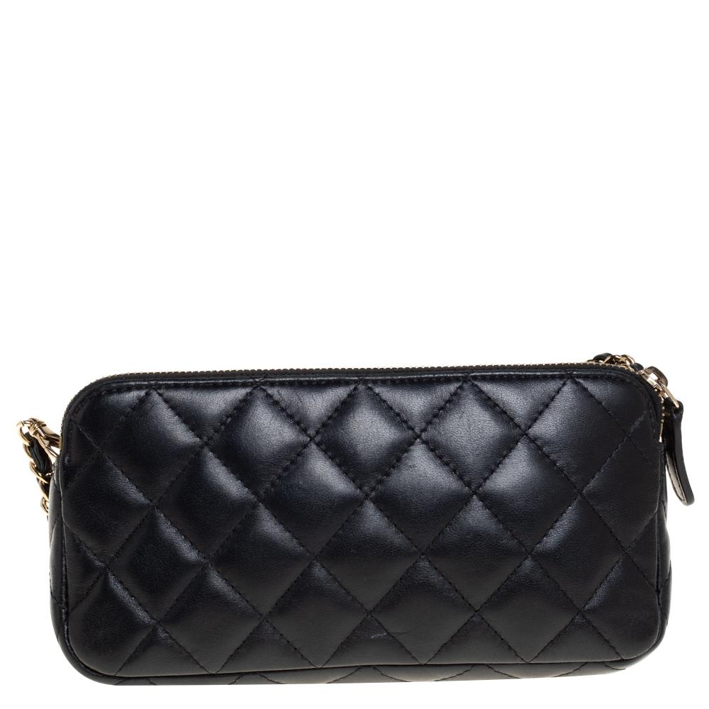 Crafted from black quilted leather, this wallet by Chanel is the bag you will carry everywhere. It features a zip-around closure, a signature interwoven chain and gold-tone hardware. The interior is lined with leather & canvas and features two