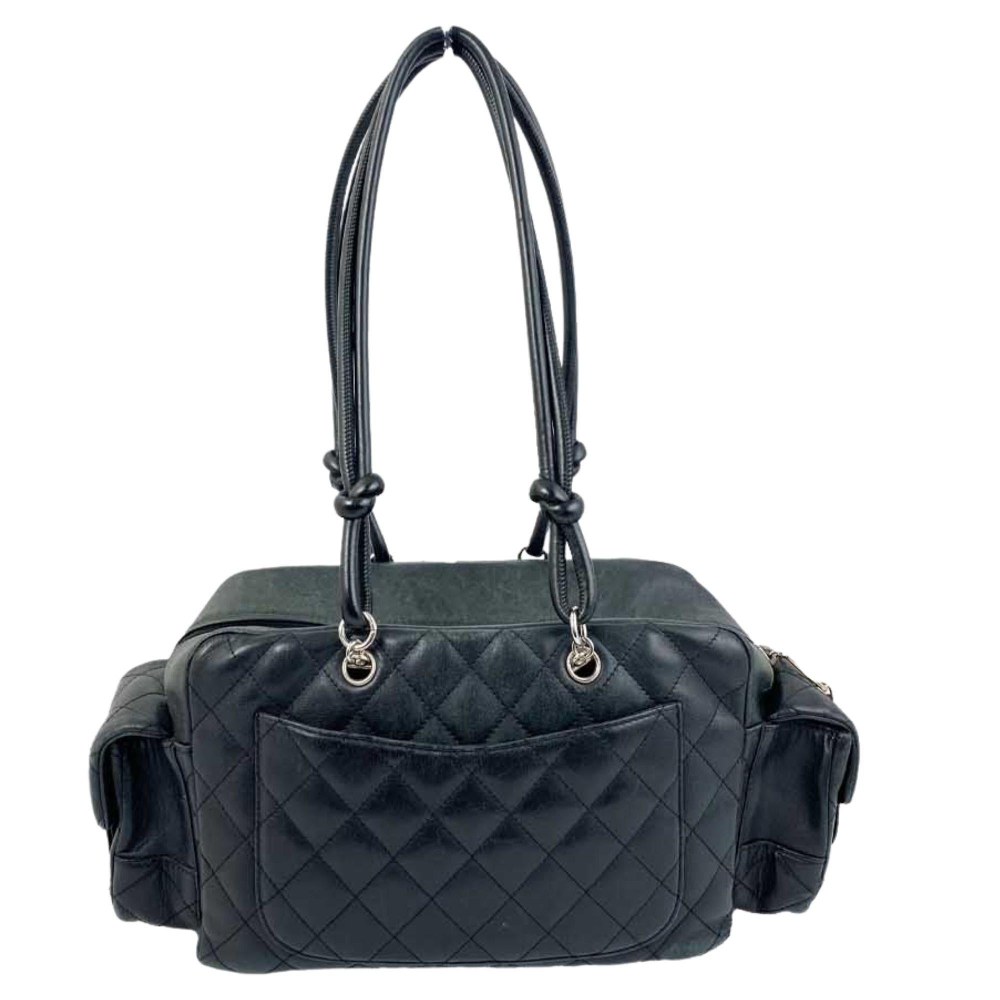 Black Chanel quilted leather hand bag. silver-tone hardware, two pockets in the front, two on either side, and one slide pocket in the back. One zipper pocket and two slide pockets on the inside. Includes original dust bag. Serial Code