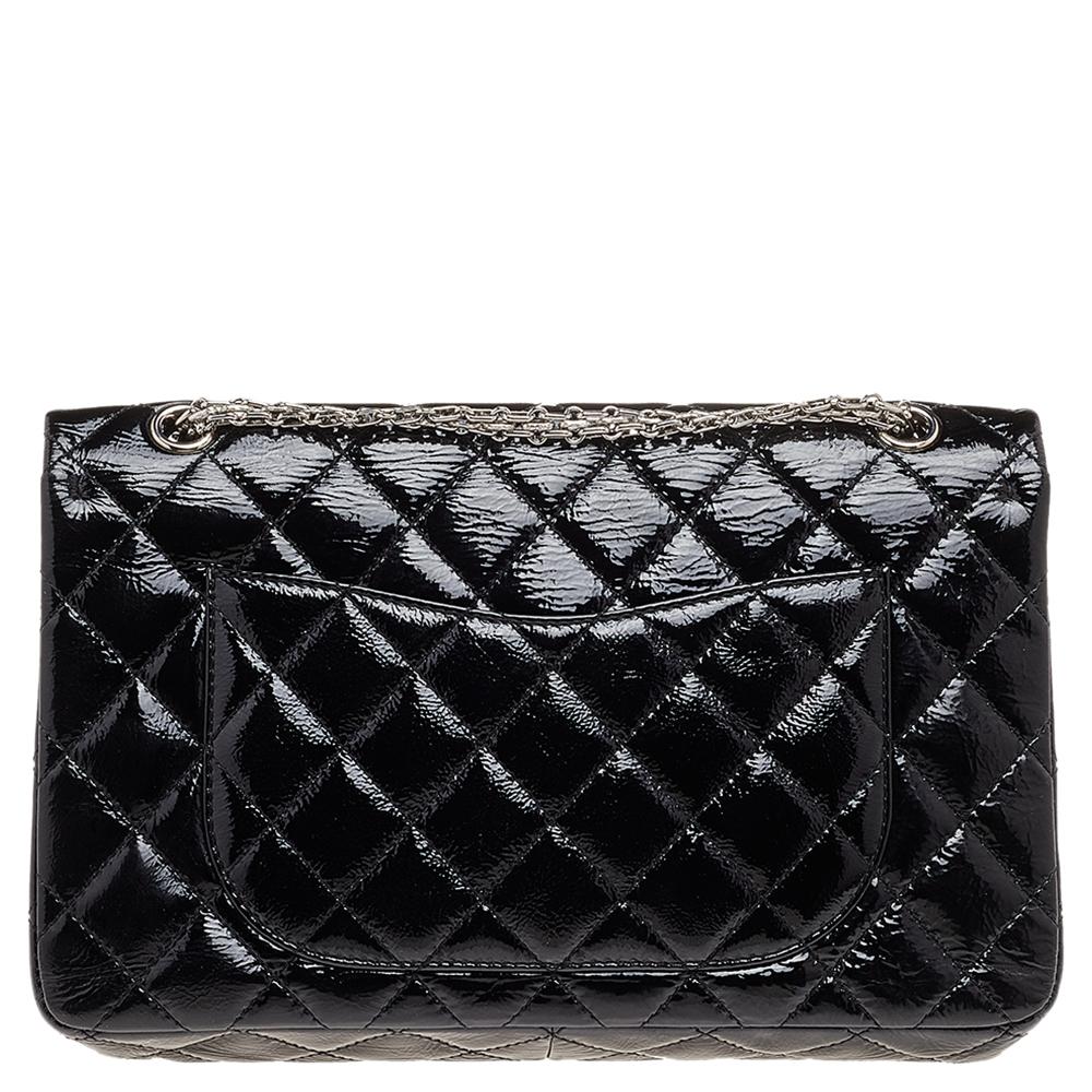 Chanel's Flap Bags are iconic and monumental in the history of fashion. This Reissue 2.55 Classic 227 Double flap is a buy that is worth every bit of your splurge. Exquisitely crafted from black patent leather, it bears their signature quilt pattern