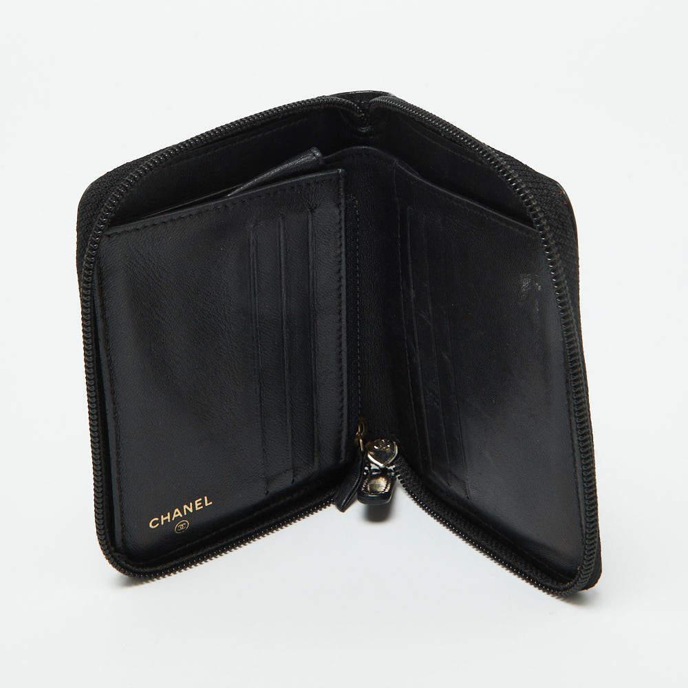 A compact and practical option to store your handy essentials this Chanel wallet is crafted from quilted leather. It has a zip around closure the brand logo on the front and is equipped with multiple compartments and a zip pocket in the leather and