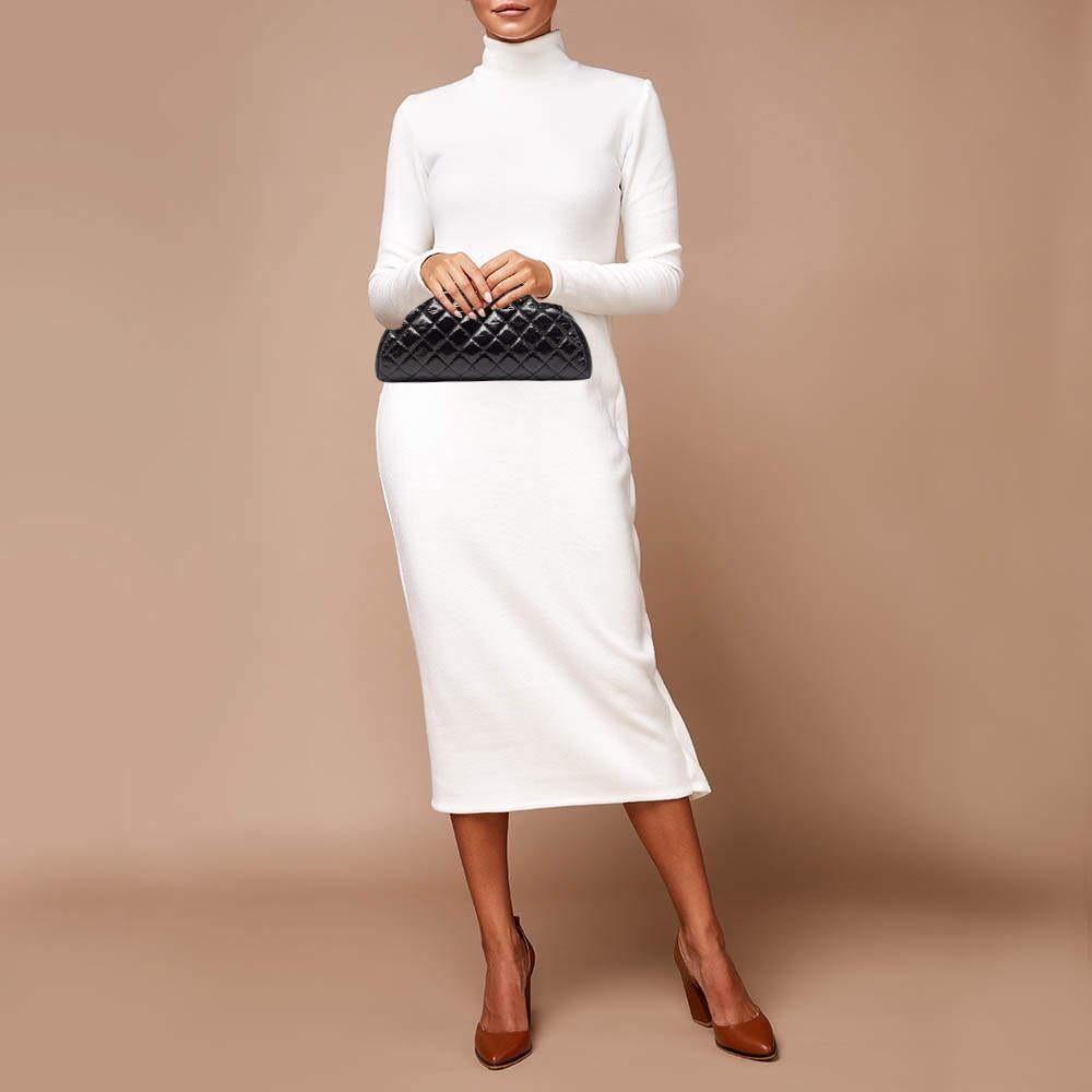 This clutch from Chanel has a timeless allure. Its classy exterior is composed of black quilted leather with kiss lock added on top. Owing to its unique shape and silhouette  this Chanel clutch remains a widely admired accessory. Add this beauty to