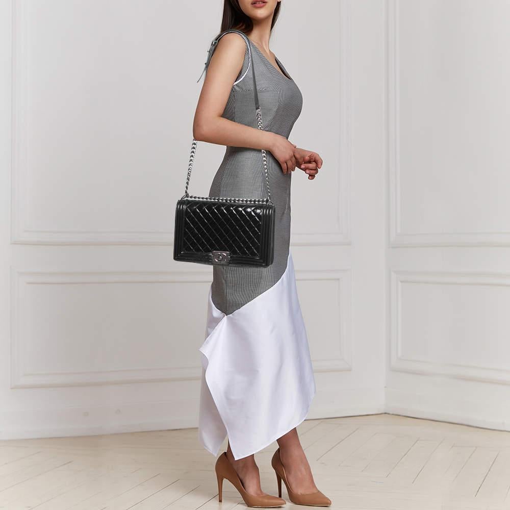 This stylish bag from Chanel has been crafted from patent leather. It opens to a capacious interior that can easily hold your everyday essentials. The bag is finished with dark ruthenium hardware.

Includes
Authenticity Card, Original Box