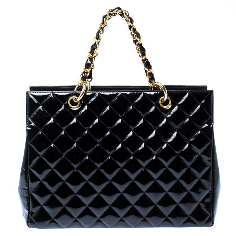 Featuring top handles with chain trims and an embossed CC logo on a quilted pattern, this Chanel black patent leather tote exudes just the right amount of sophistication. The bag features a capacious compartment lined with leather. It has gold-tone