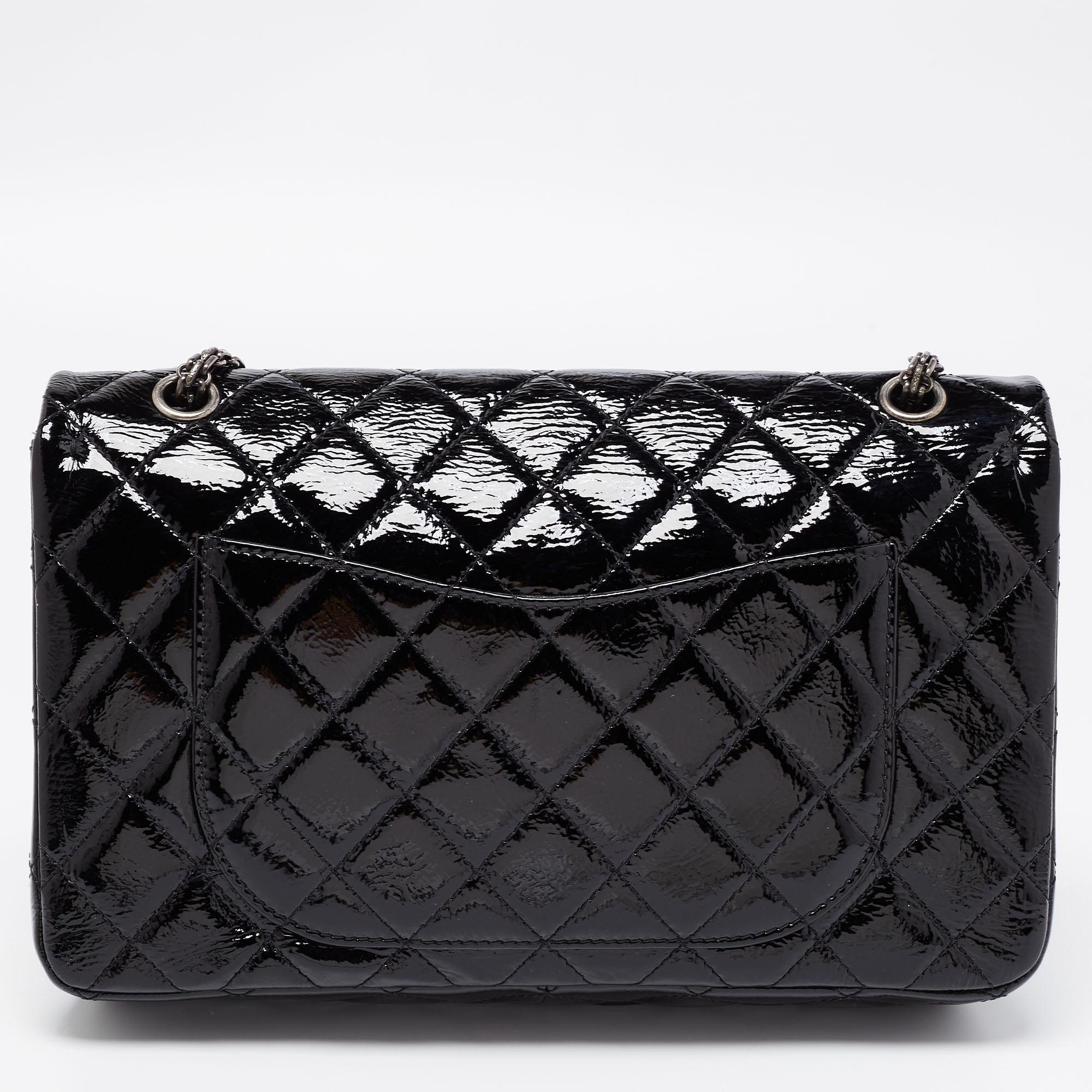 Introduce Chanel's irreplaceable style to your closet with this Reissue 2.55 Classic 227 Flap bag. Crafted using black patent leather, the bag has a signature quilted exterior, the Mademoiselle lock on the front, and a leather-lined interior.