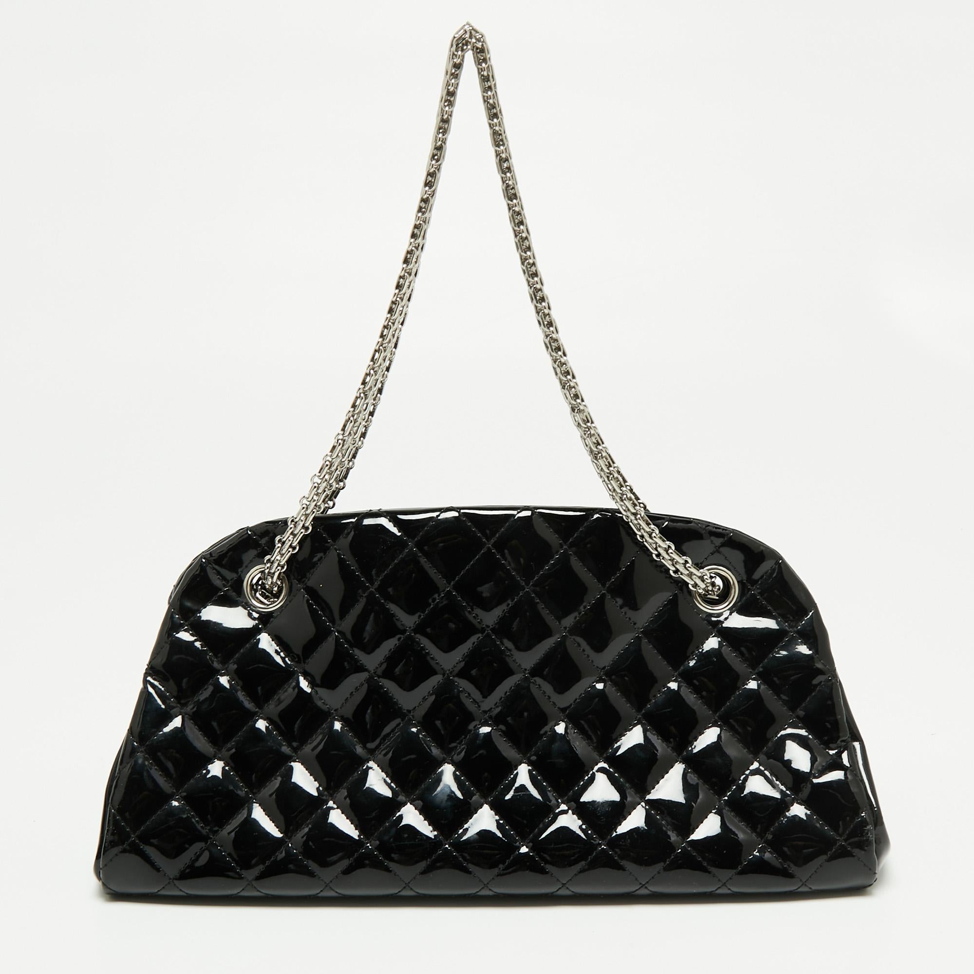The Just Mademoiselle is another loved bag from Chanel. Crafted from patent leather, this beauty in black is lined with canvas and held by chain handles. This bag has well-sized compartments for your necessities and a CC charm for you to