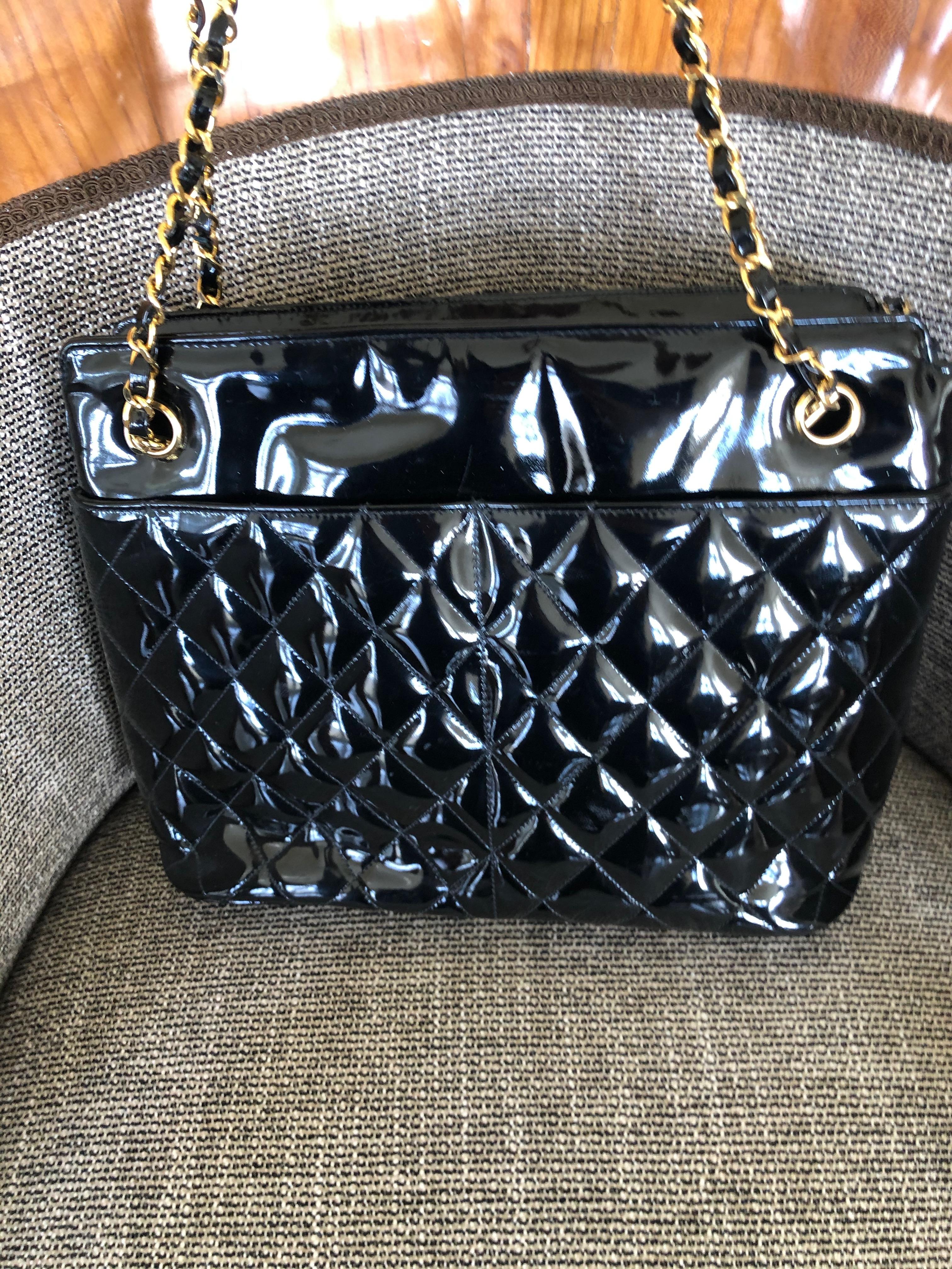 Chanel Black Quilted Patent Leather Tote Bag with Gold Chain Handle.
12