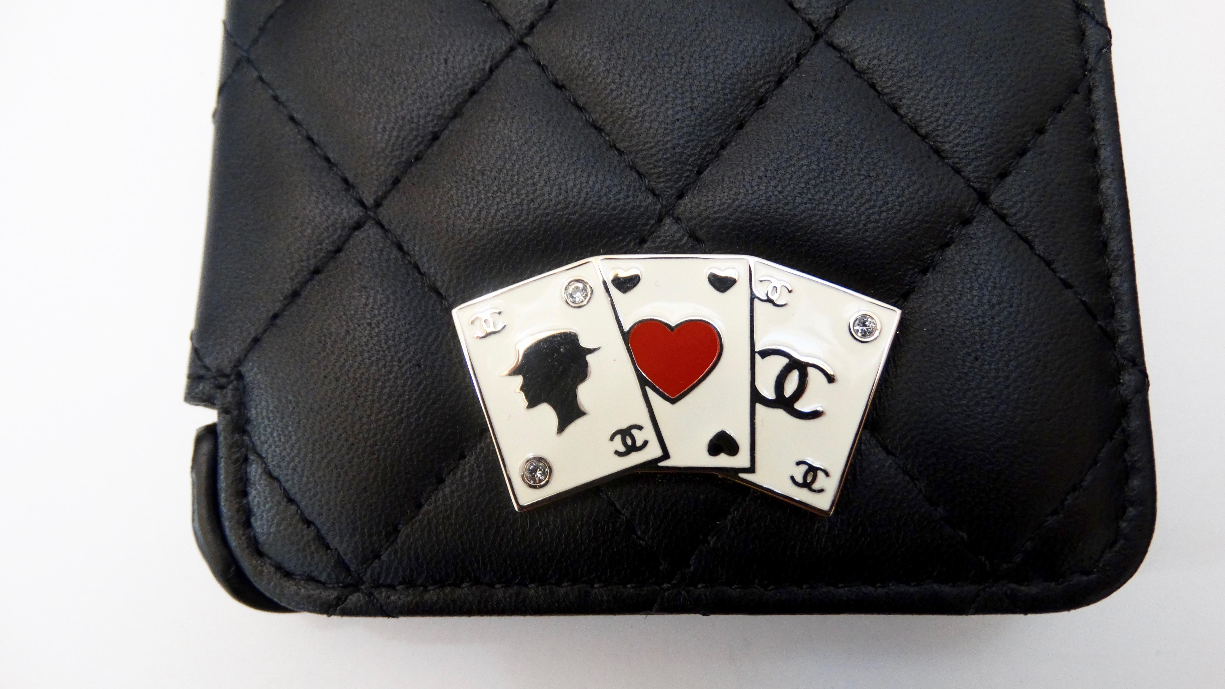 Dress up your phone with this adorable Chanel iphone case! Circa recent 2000s, this iphone 8 phone case is made from soft black leather and features the signature quilted stitching. Front face includes a hand on enamel casino cards decorated with
