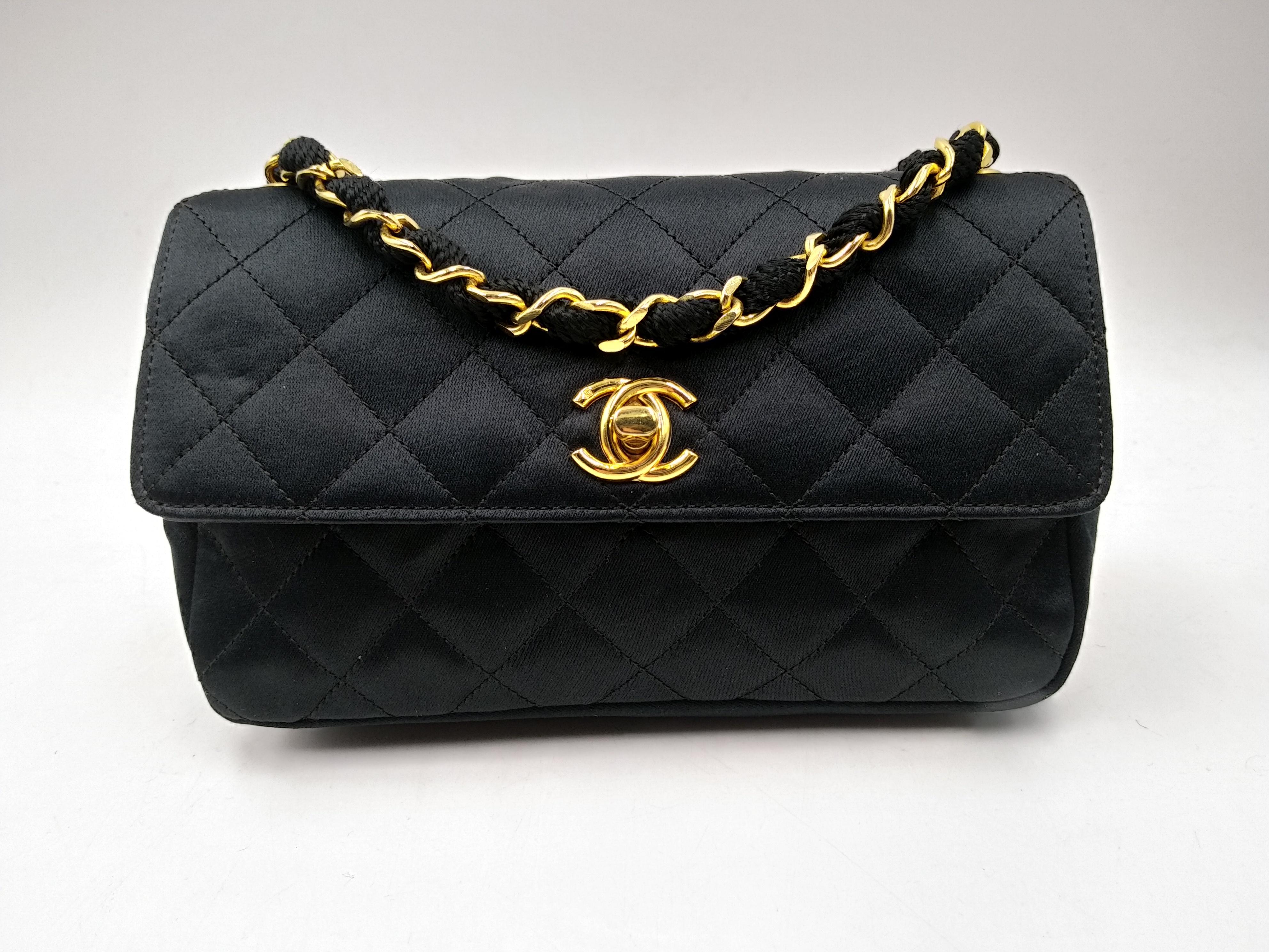 Chanel Black Quilted Satin Mini Flap Bag with Gold Hardware,  ( 1986/1988)
- 100% authentic Chanel
- Black Quilted Satin
- Long chain and fabric entwined strap
- The interior is lined in a tonal textile material
- One flat pocket inside
- Flap top