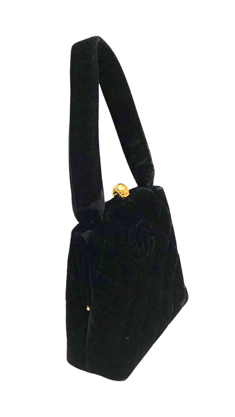 - Vintage Chanel black quilted velvet handbag from year 1994 to 1996.

- Stitching CC logo. 

- Gold toned hardware CC quilted ball closure. 

- Gold lambskin leather interior. One interior pocket zip closure. 

- Size: 16cm x 15cm x 6cm. Handle