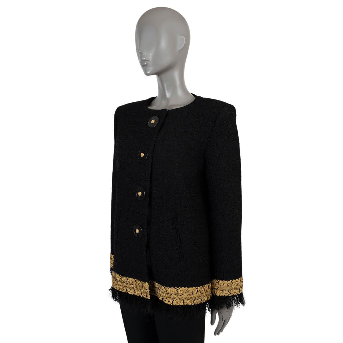 100% authentic Chanel tweed jacket in black rayon (46%), nylon (46%), cotton (4%) and polyester (4%). This masterpiece is adorned with gold metallic embroidery and delicate fringe trim along the cuffs and bottom hem. Features a collarless, boxy