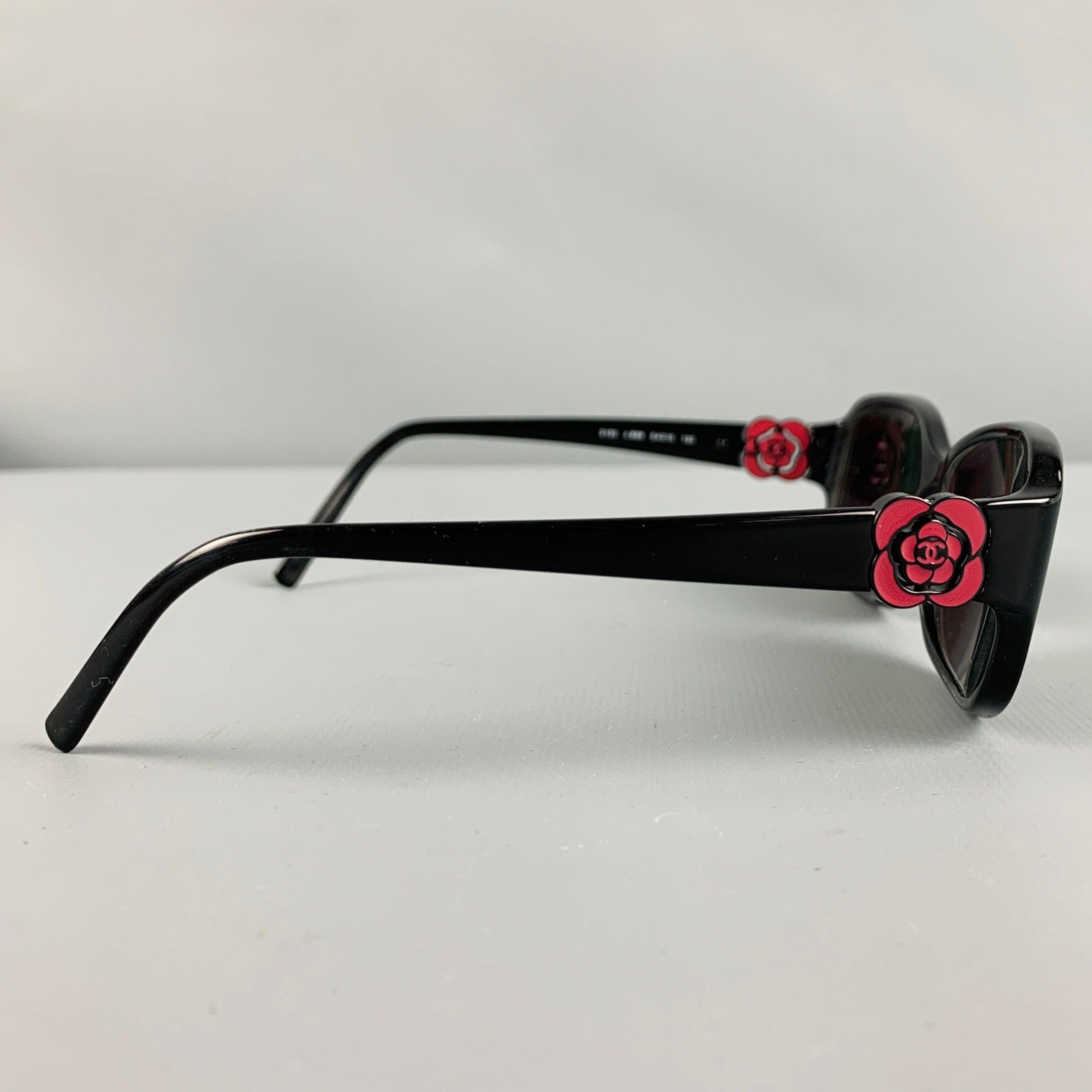 CHANEL sunglasses
in a black & red acetate featuring signature red camellia temple details with Chanel monogram. Comes with case. Made in Italy.Very Good Pre-Owned Condition. Lenses are prescription and will need to be replaced. 

Marked:  