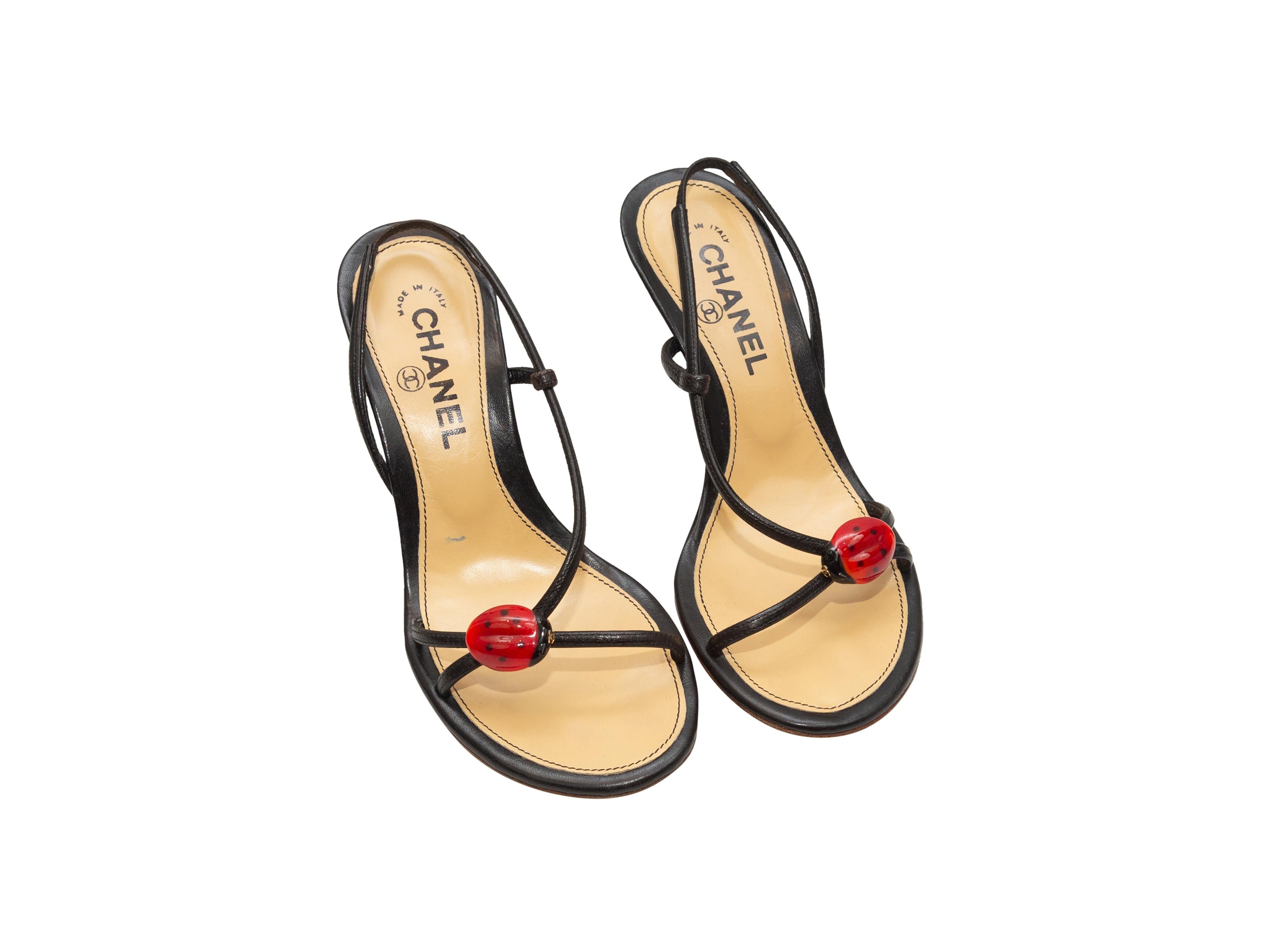Product details: Black leather heeled ladybug sandals by Chanel. Stacked heels. Designer size 36.5. 3.5