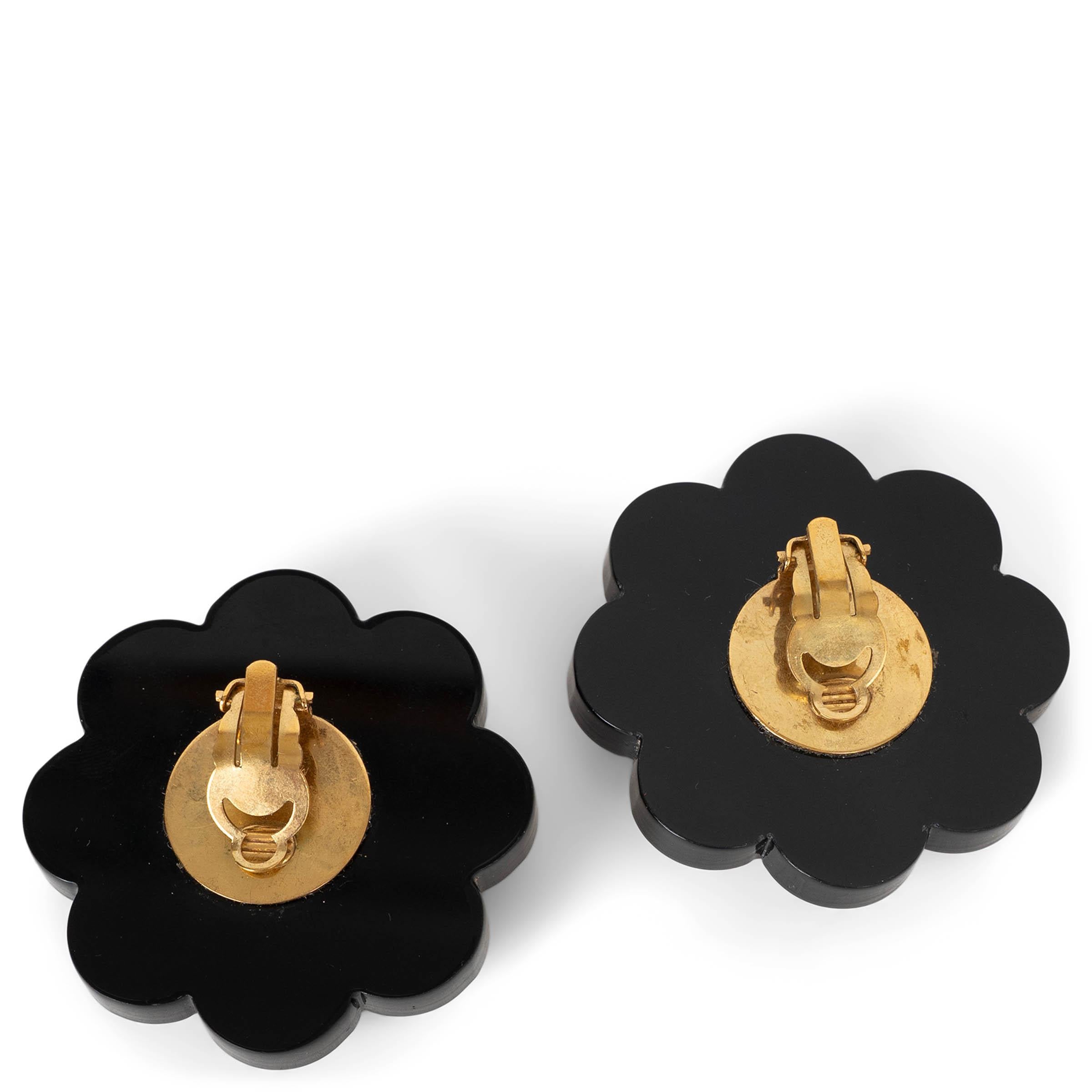 These 100% authentic Chanel clip-on earrings are crafted from pearly white imitation pearls sculpted into elegant camellia flowers, creating a soft, feminine silhouette emblematic of the House’s most iconic bloom. A beautifully delicate and