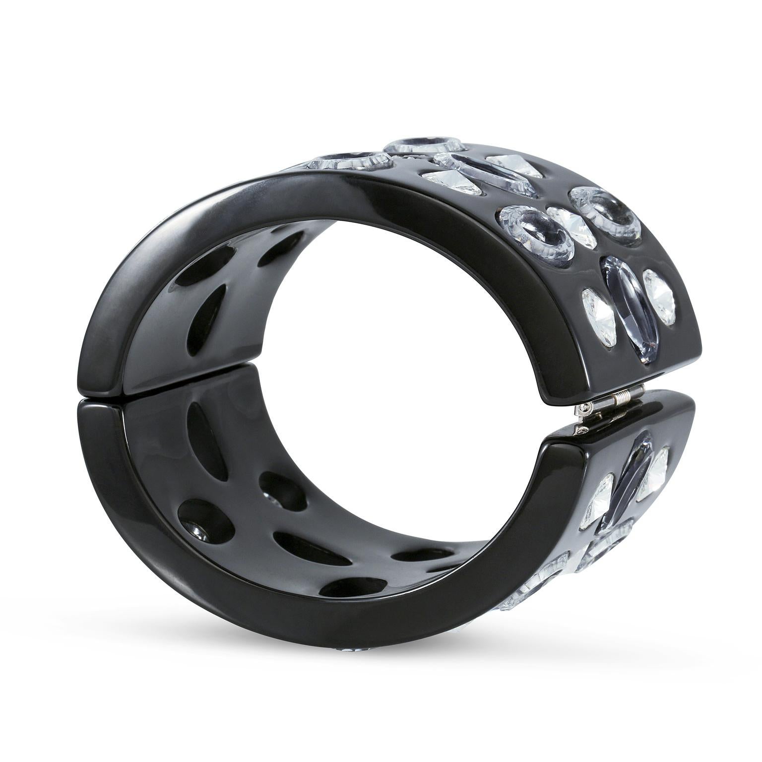 This authentic Chanel Black Resin and Crystal Cuff is in pristine condition.  Dramatic and substantial black resin hinged cuff is adorned with oval cutouts and crystal embellishments.   Pouch or box included.

