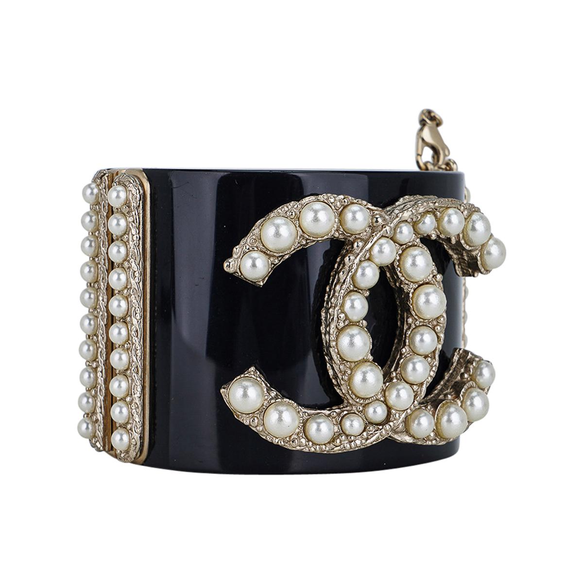 Mightychic offers a c 2011 Chanel Black Resin/Pearl Encrusted Clamper Cuff bracelet.
Bold pearl encrusted CC with pearls along the both sides of the cuff.
Spring hinge closure.
This fabulous bold statement cuff is timeless and perfect to dress up or