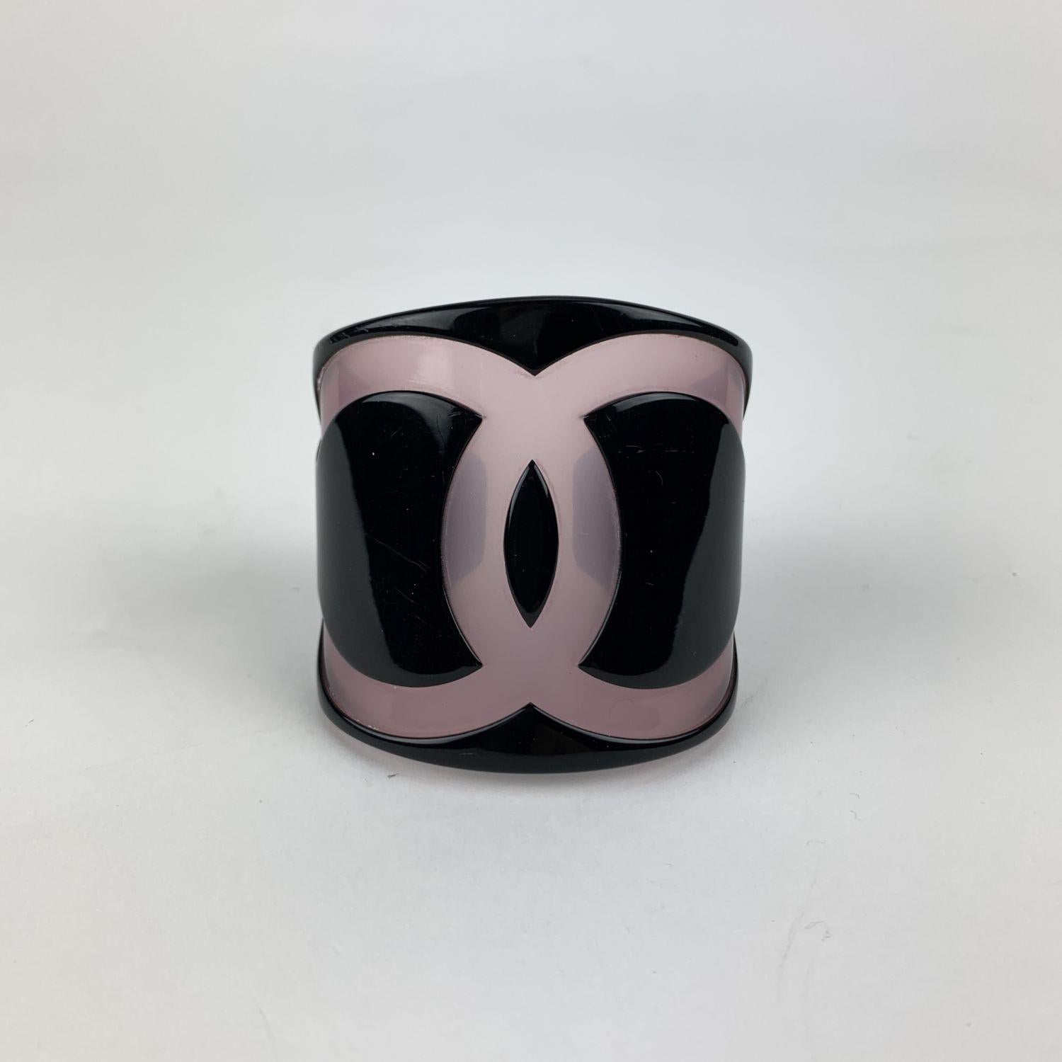 Lovely cuff bracelet by CHANEL. Black resin with big semi- transparent CC logo at center. Open design. Marked 'CHANEL 01 CC P MADE IN FRANCE' internally. Height: 2.3 inches - 6 cm. Will fit up to approx. 6 inches - 16.2 cm wrist (for very small