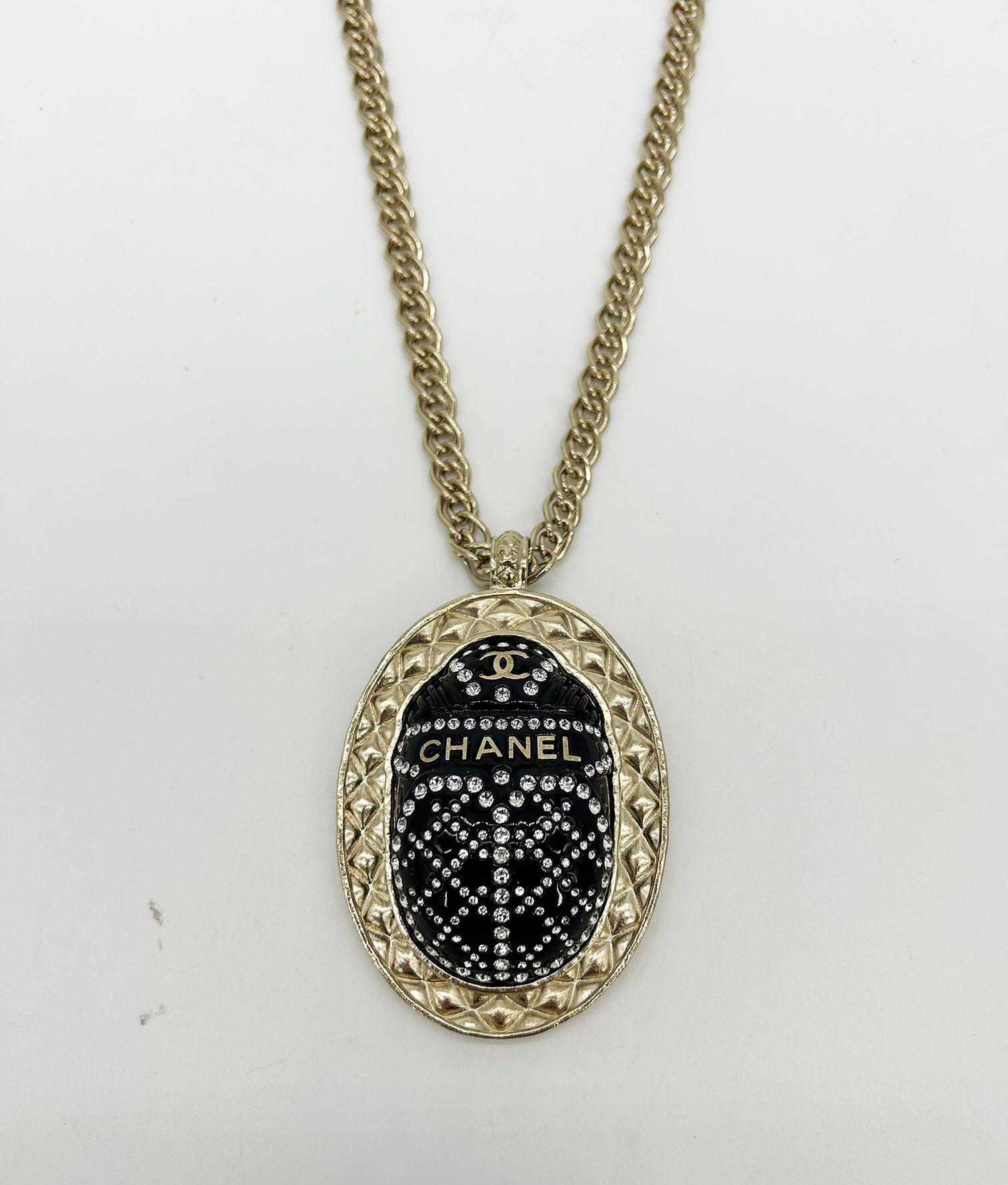 Chanel Black Rhinestone Egyptian Scarab Necklace in like new condition. from fall/winter 2019 collection with gold chain necklace and 2x2.75