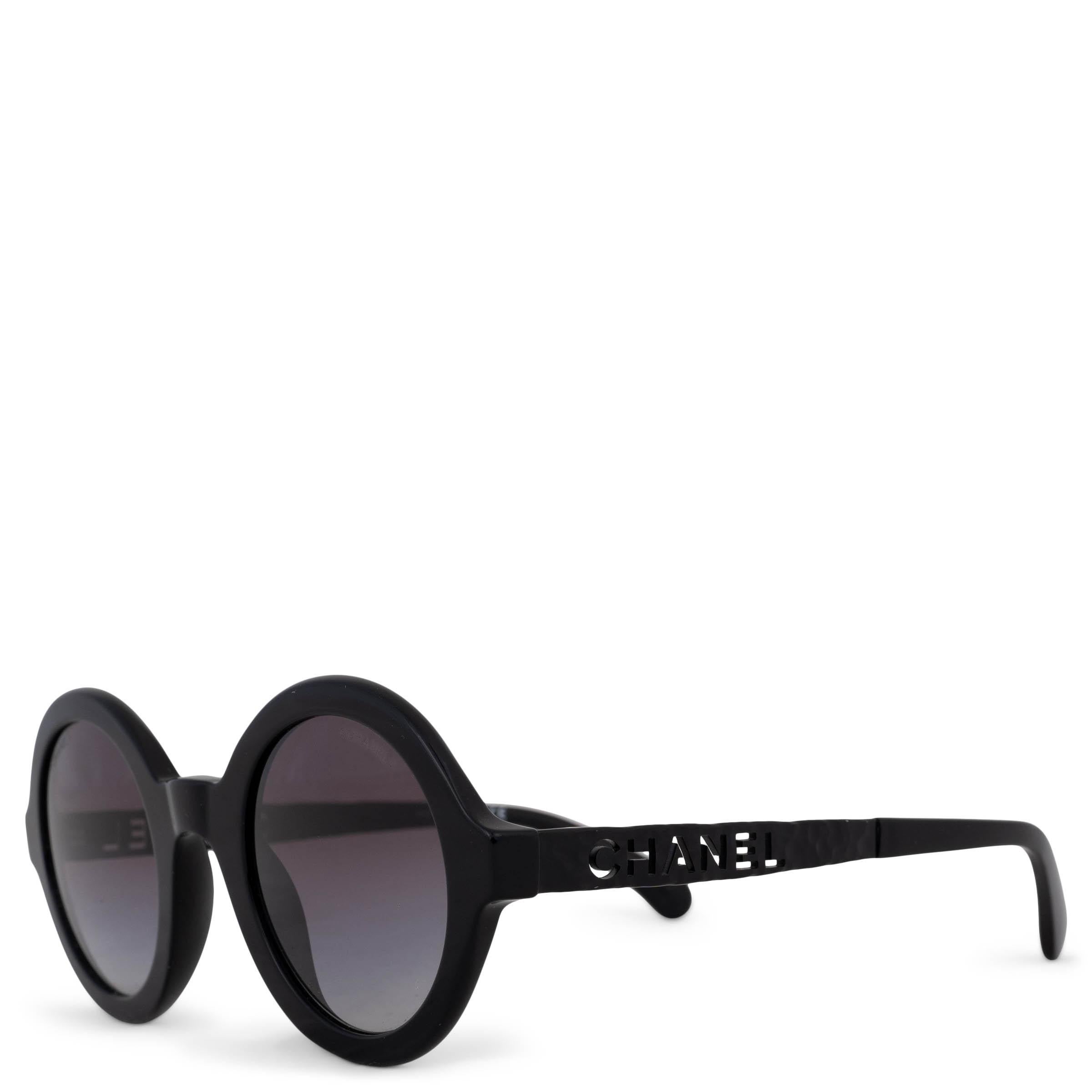 This 100% authentic Chanel sunglasses in black acetate embody understated sophistication. Designed with round frames and gradient grey lenses, they feature a distinctive signature cut-out at the temples, adding a subtle yet iconic detail. Have been
