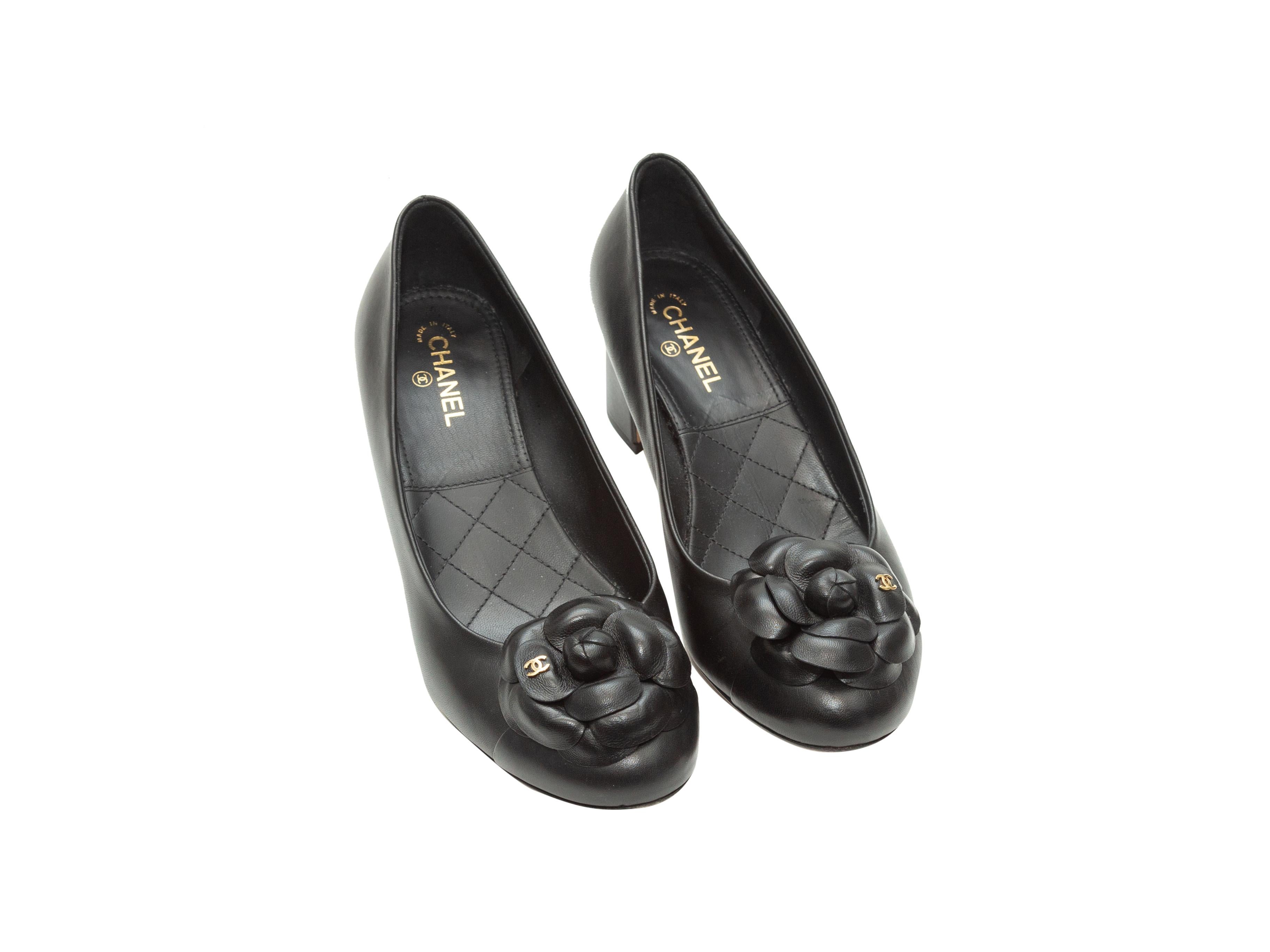 Product details: Black leather round-toe pumps by Chanel. Camelia accents at toes. Block heels. Designer size 39. 2.25