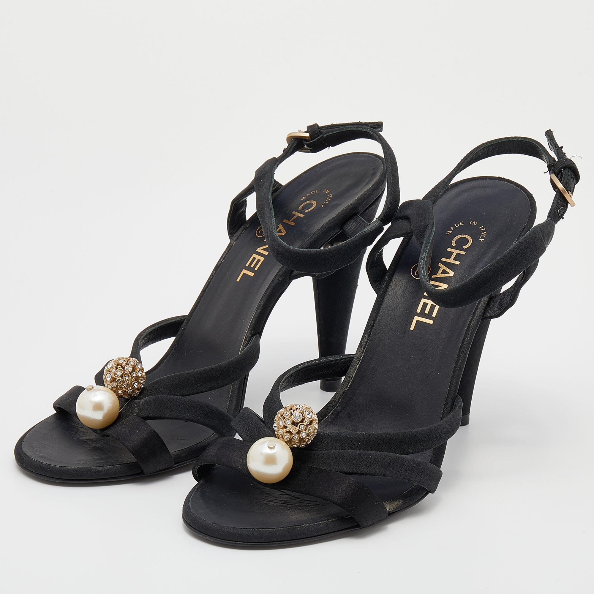 Adorned with a pearl and crystal embellishment, these Chanel sandals will add an instant dose of glam to your outfit. Their 11cm heels are designed with a 'CC' motif on them and these shoes are secured with an ankle buckle closure. Created from