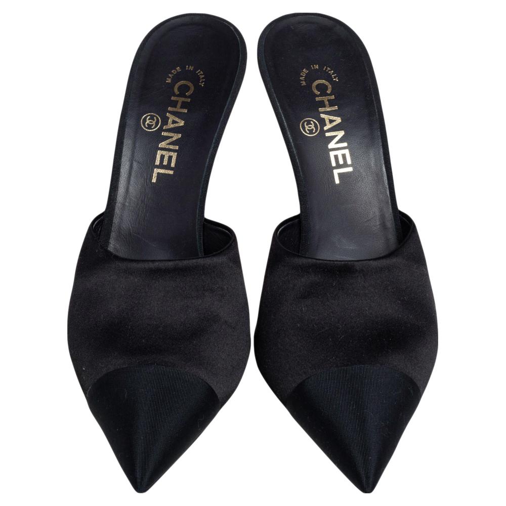 Chanel's creations are coveted around the world for their exquisite craftsmanship and timeless designs. These slip-on mules are no different. Crafted from quality satin, they are styled with pointed toes and 10 cm heels with faux pearl