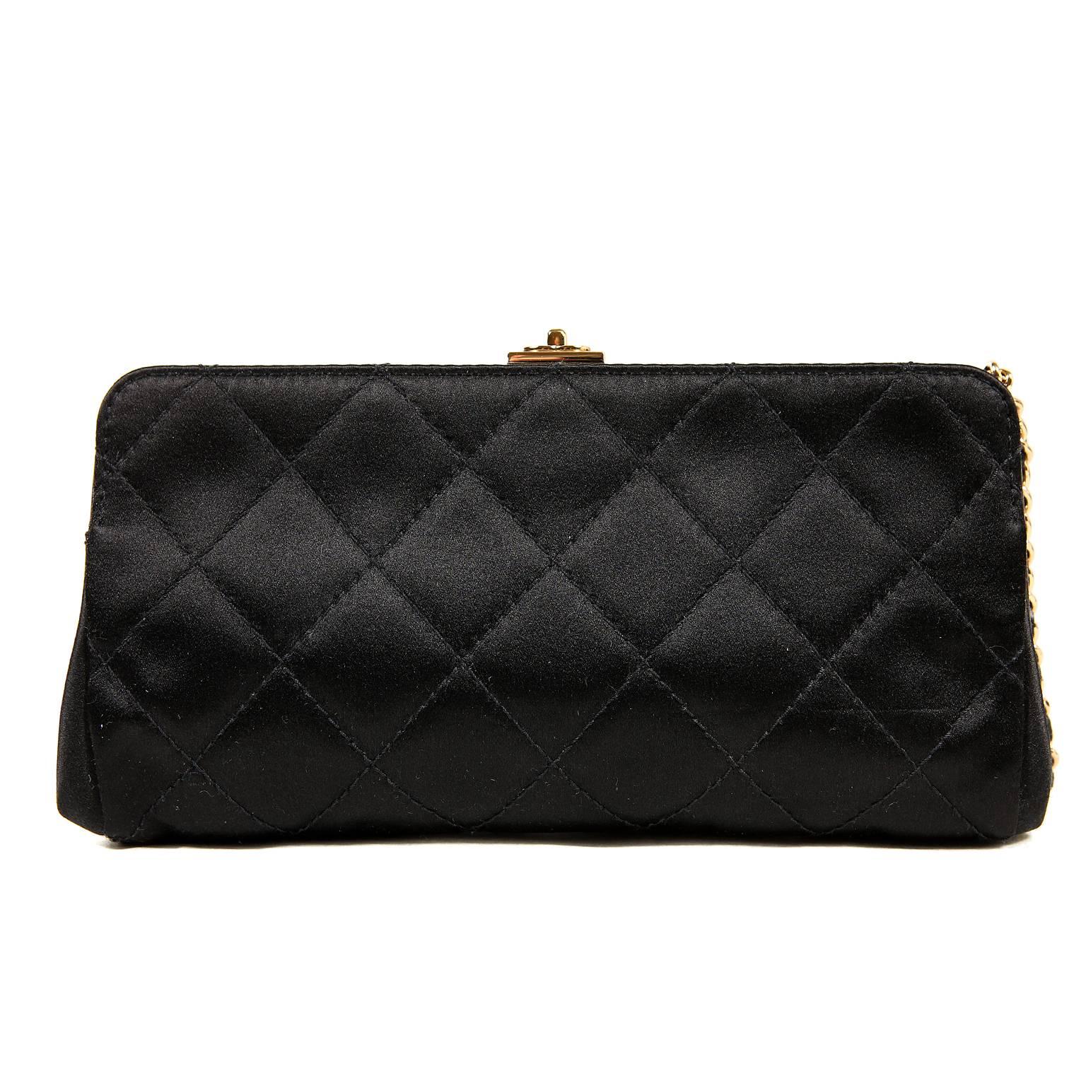 Chanel Black Satin Quilted Clutch- MINT
Perfectly sized, this ultimate classic is a brilliant addition to any wardrobe. 
Black satin framed clutch is quilted in signature Chanel diamond pattern. Black leather trims the top with a gold tone