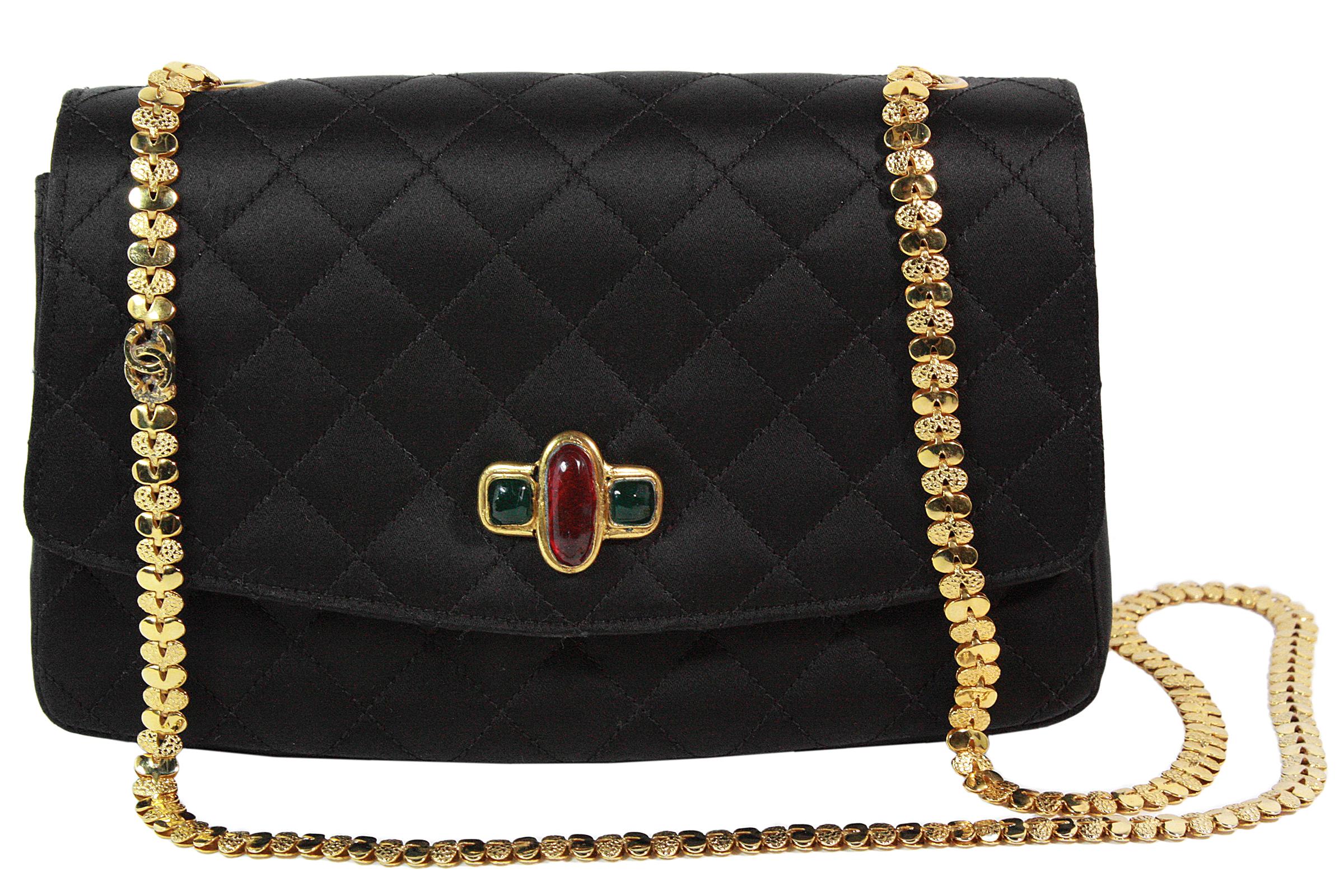 Chanel crossbody bag
Made in France
Black quilted satin  
Attached red and green gripoix (poured glass) 
Inside pocket 
Gold decorative CC chain strap
Chain strap length: 34 inches 
Black satin lining 
Comes with dustbag
Serial number: 116669 (no