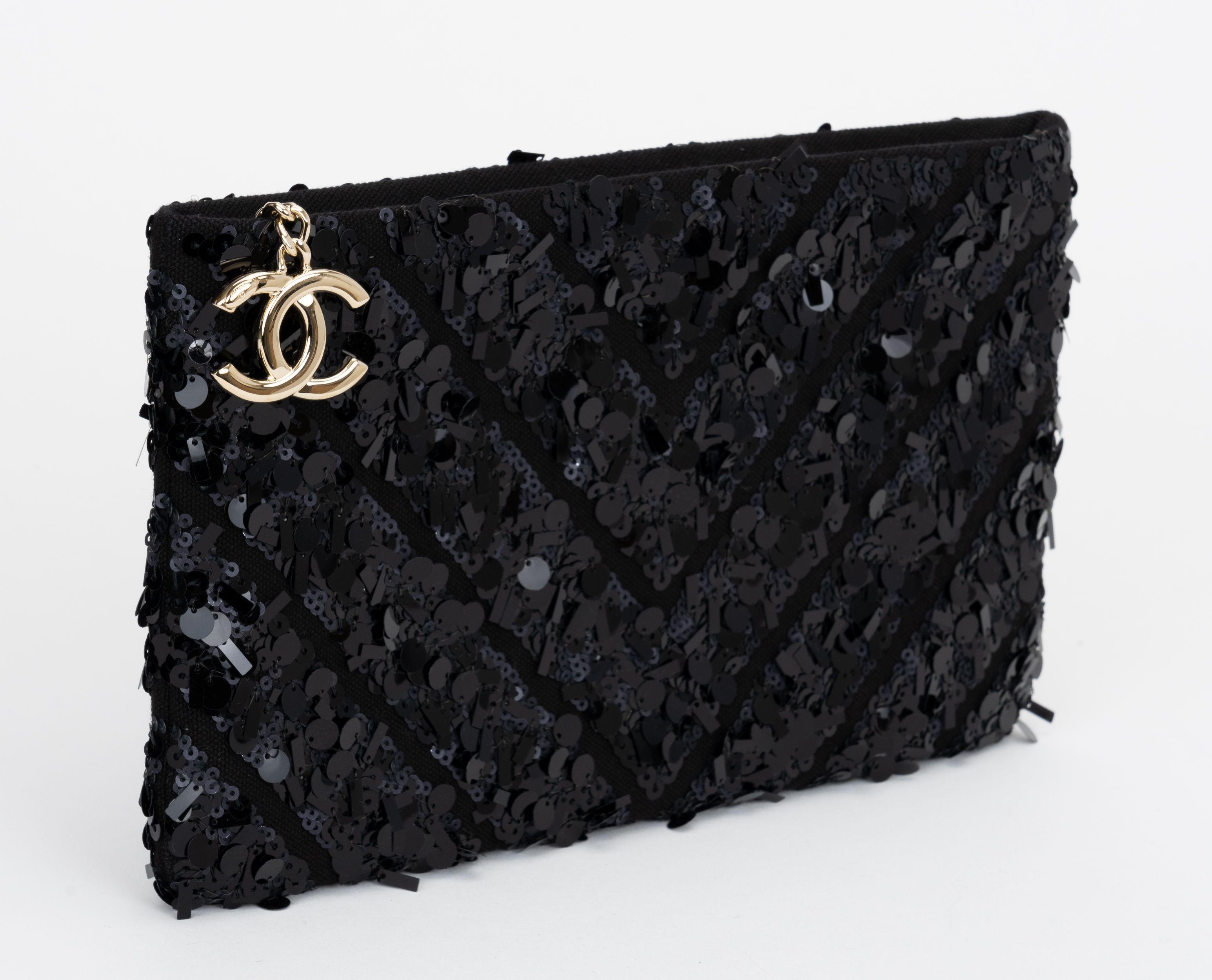 Chanel chic and timeless black sequins evening clutch, silver logo zipper pull, leather lining.  Comes with hologram, id card and original dust cover. Collection 25.