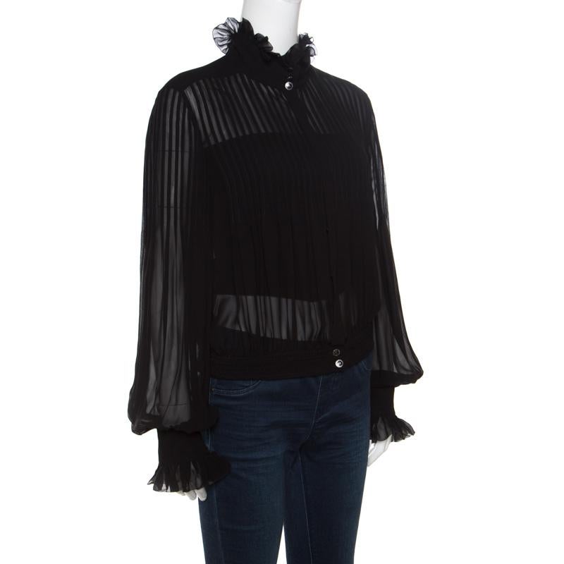 Beautiful to look at, this top from Chanel has been created to suit your fashionable taste. It is made of quality silk and it has blouson sleeves, a high ruffle neckline and pintucks all over. Graceful and very modern, this top is a buy your
