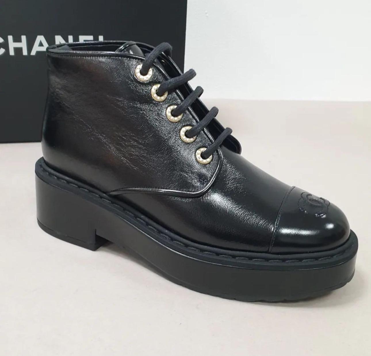 These stylish lace up boots are crafted of crumpled shiny black calfskin leather. 
They feature rounded black, smooth leather cap toes, a 1.75-inch heel, and shoelace grommets accented with resin pearls.
Sz.39.5
New. Never worn
Come with dust bag