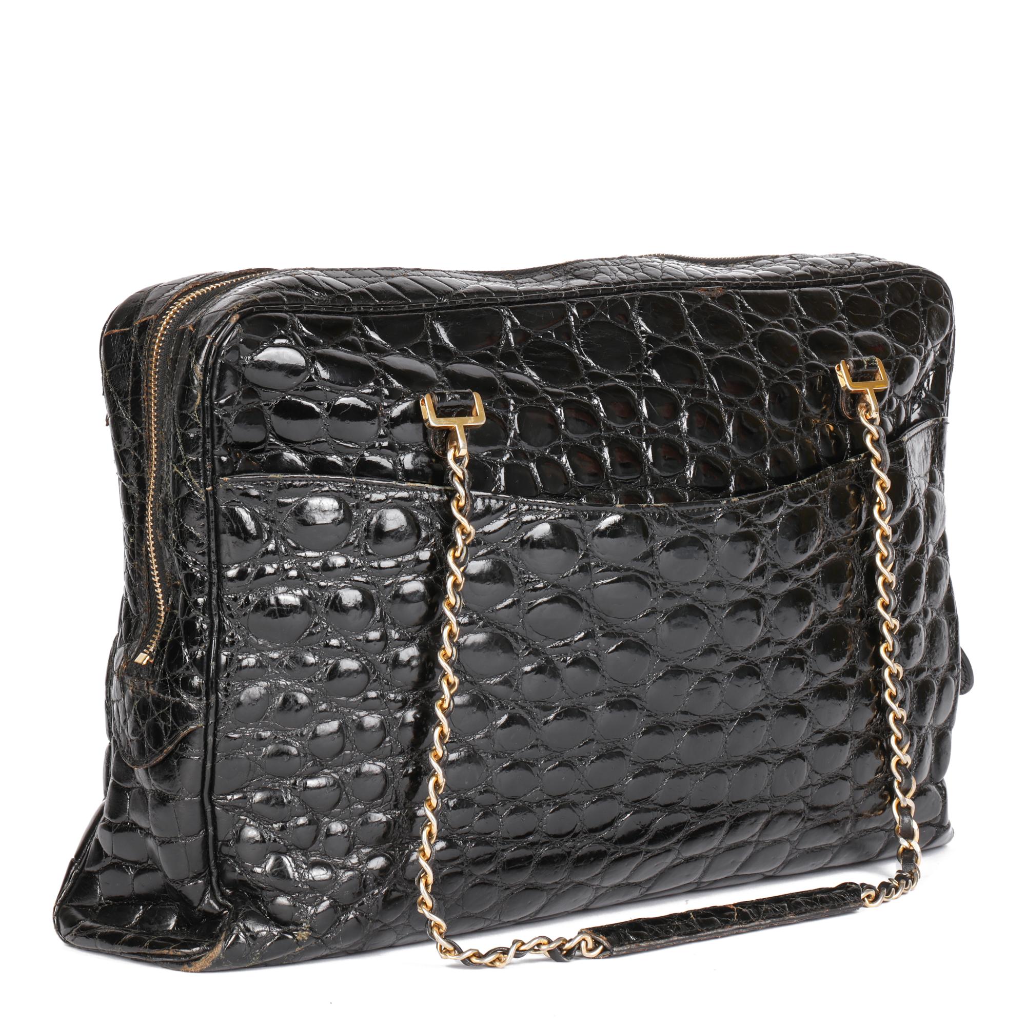 CHANEL 
Black Shiny Crocodile Leather Vintage Camera Bag

Serial Number: X
Age (Circa): 1980
Accompanied By: Chanel Dust Bag
Authenticity Details: (Made in France)
Gender: Ladies
Type: Shoulder

Colour: Black
Hardware: Gold
Material(s): Shiny