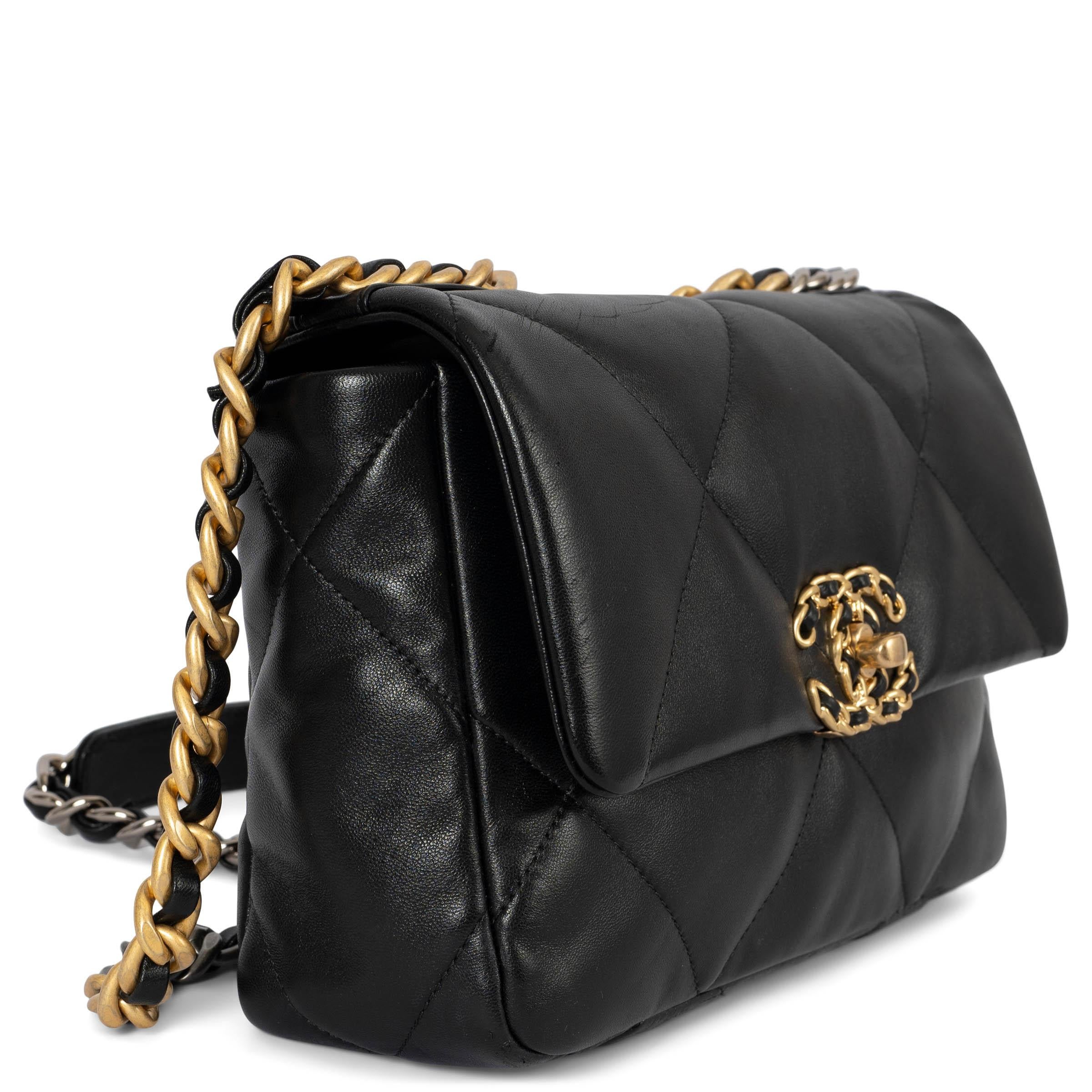 100% authentic Chanel 19 Medium shoulder bag in black smooth shiny lambskin with mixed hardware that features aged gold-tone, ruthenium and silver-tone. The interior is lined in a red grosgrain with one zipper pocket against the back and an exterior