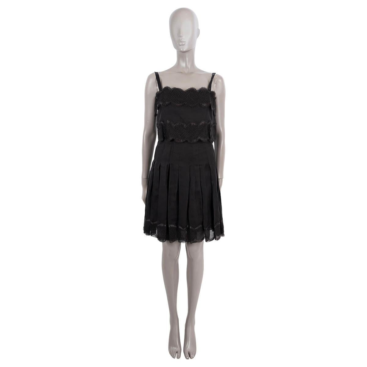 100% authentic Chanel cocktail dress in black silk (100%) with lace details. Closes with zipper and buttons and bow on the back. Lined in silk (100%). Has been worn and is in excellent condition.

2006 Spring/Summer

Measurements
Model	06P P28237