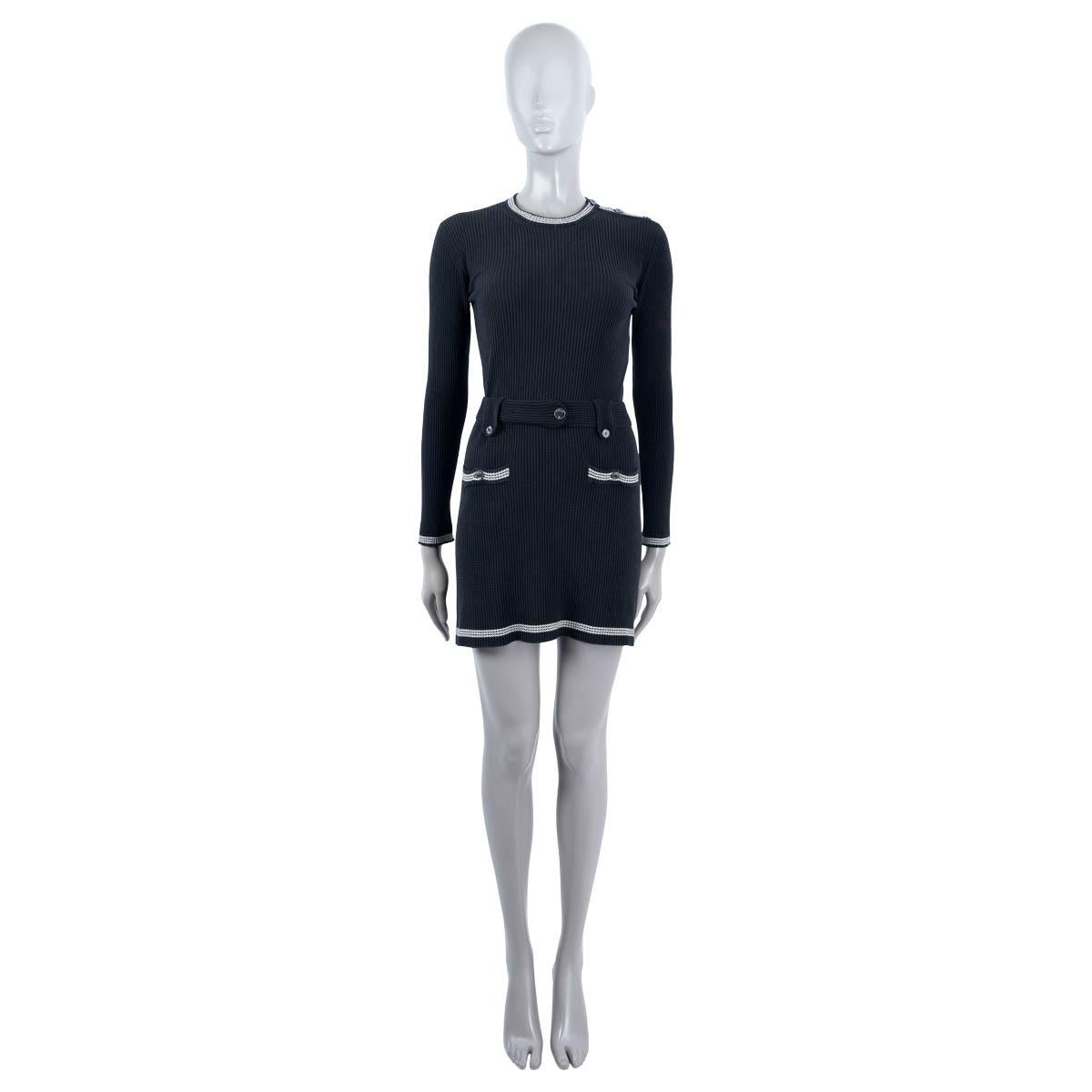 100% authentic Chanel rib-knit dress in black silk (78%), polyamide (17%) and elastane (5%). Features contrast ivory striped trims, a crew neck, two buttons pockets, belt loop and matching fabric belt. Opens wit three buttons at the neck. Unlined.