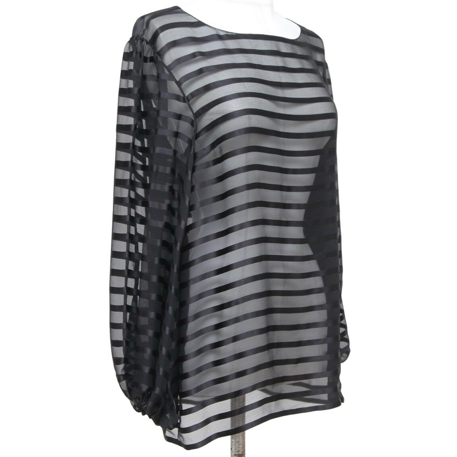 GUARANTEED AUTHENTIC CHANEL 2013 BLACK STRIPED SILK BLOUSE

Design:
- Sheer black silk long sleeve blouse.
- Bateau neckline.
- Slip on.
- Elasticized at cuffs.
- CC plaque at left hip.

Material: 100% Silk

Size: 38

Measurements (Approximate laid