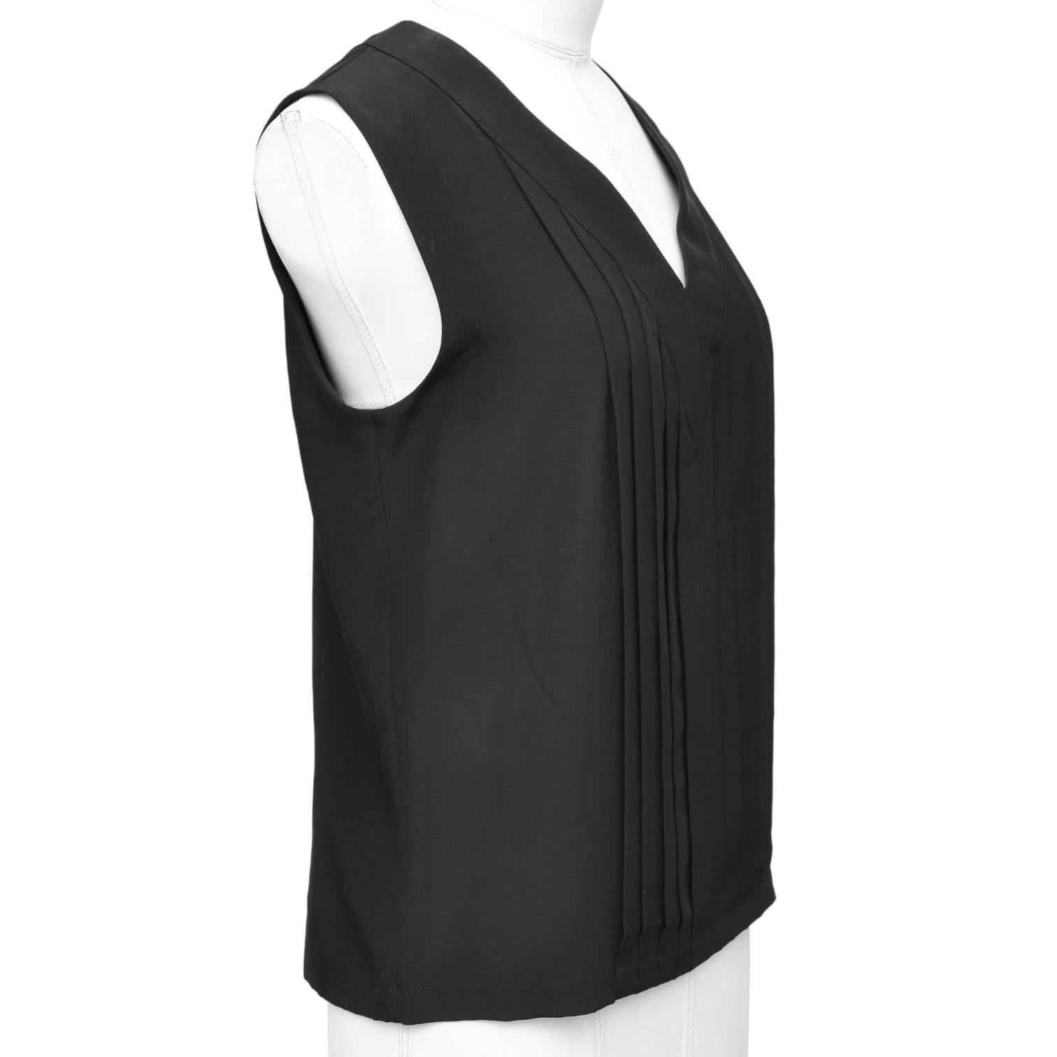 GUARANTEED AUTHENTIC CHANEL SLEEVELESS BLACK SILK BLOUSE

Design:
 - Sleeveless lightweight black silk blouse.
 - V-neckline, pleated front.
 - Rear covered signature buttons.

Material: 100% Silk

Size: 36

Measurements (Approximate laid flat):
 -