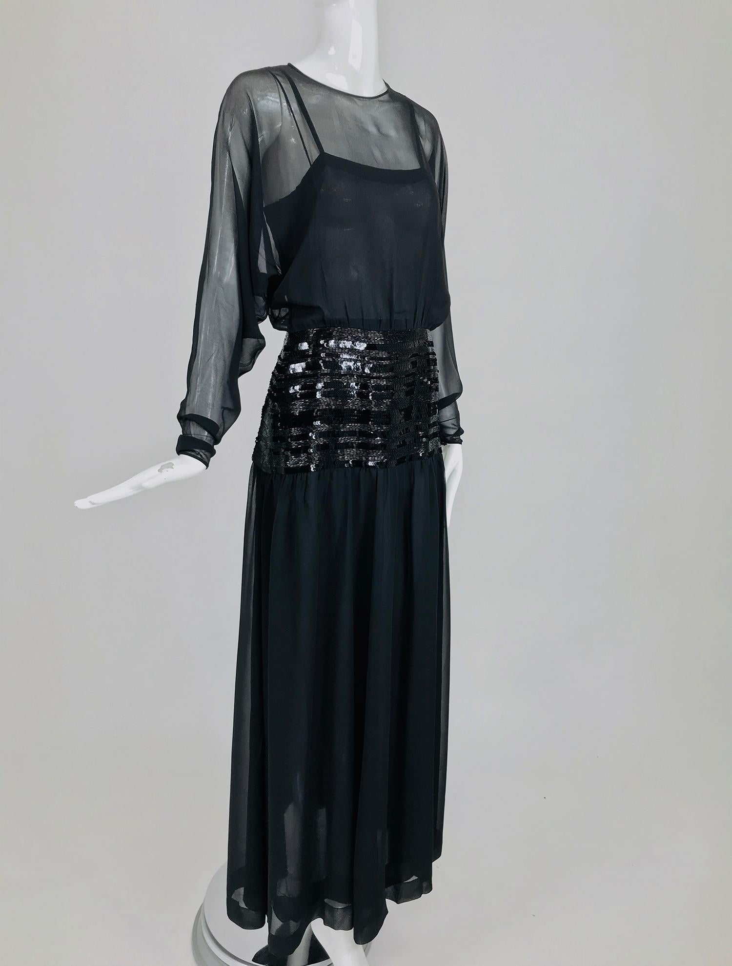 Chanel sheer black silk chiffon beaded hip, dolman sleeve evening gown from the 1980s. Gorgeous gown for any major event, this dress is truly spectacular.  Sheer black silk chiffon dress has a jewel neckline with long bat wing sleeves that taper to