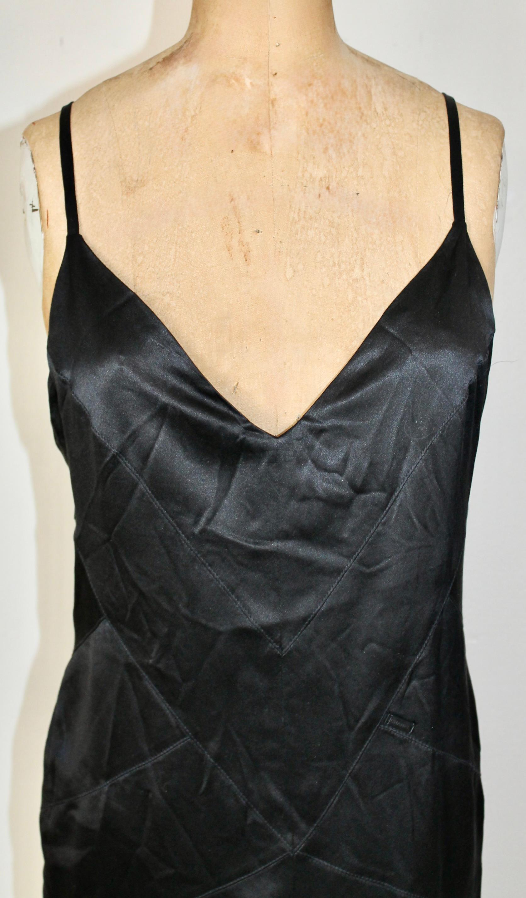 Karl Lagerfeld for Chanel designed 'little black dress'
with black & white spaghetti straps. Lagerfeld continues  Chanel's technique of crisscross piecing as a structural device. Metal Chanel tag sown on front side of dress.