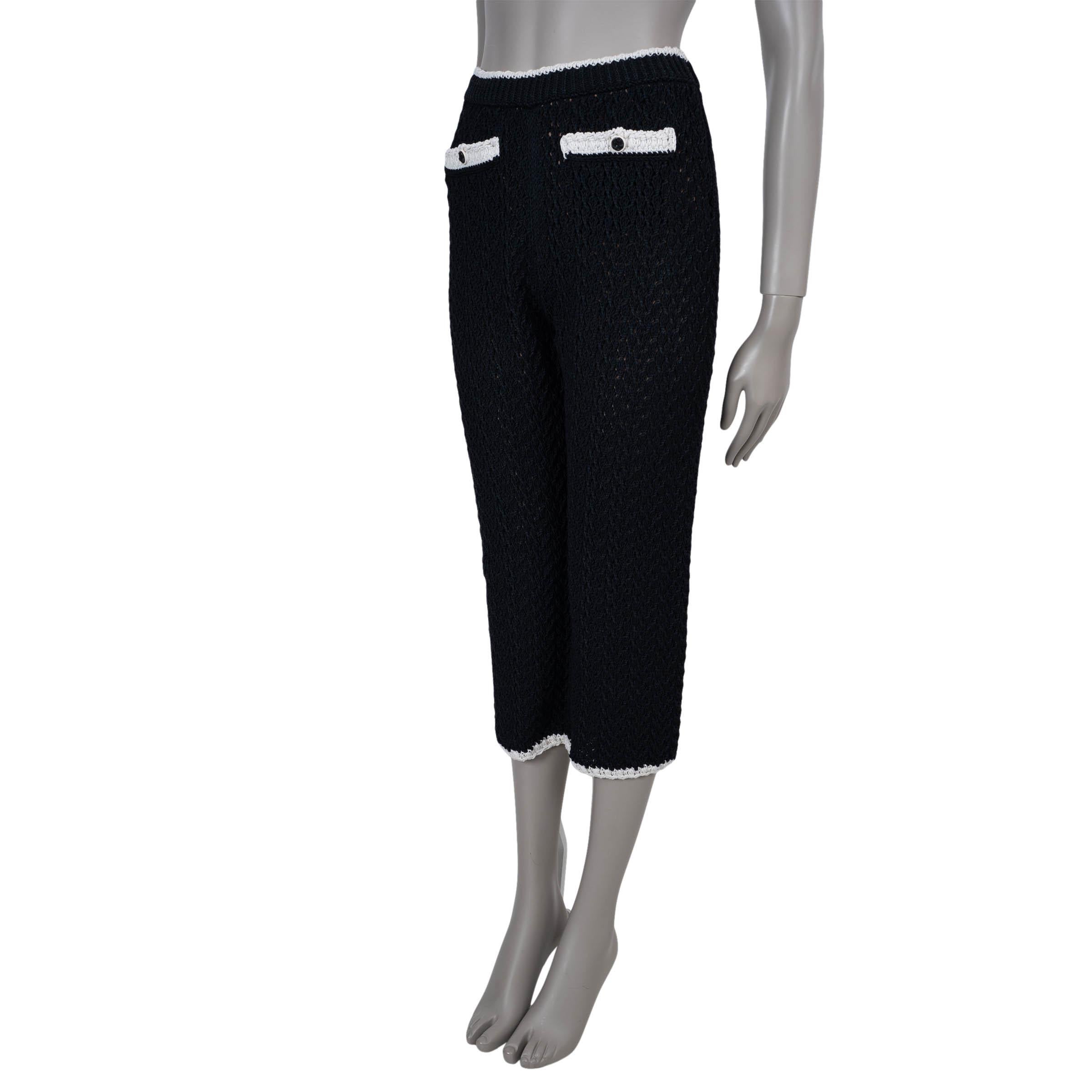 This 100% authentic Chanel pants in black semi-open crochet silk (54%) and cotton (46%) are a refined blend of texture and elegance. Accented with cream trims, they feature a mid-rise waist and straight-leg silhouette for a timeless fit. Two