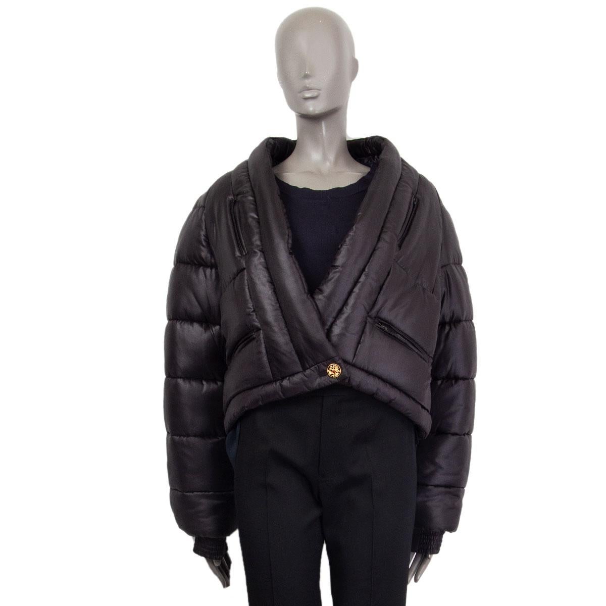 Chanel 'Paris-Moscow' double-breasted puffer jacket in black silk (100%). With v-neck, ribbed cuffs, CC crest patch on one arm, and four zipper pockets on the front. Closes with one black and golden CC crest button and one concealed butoon on the