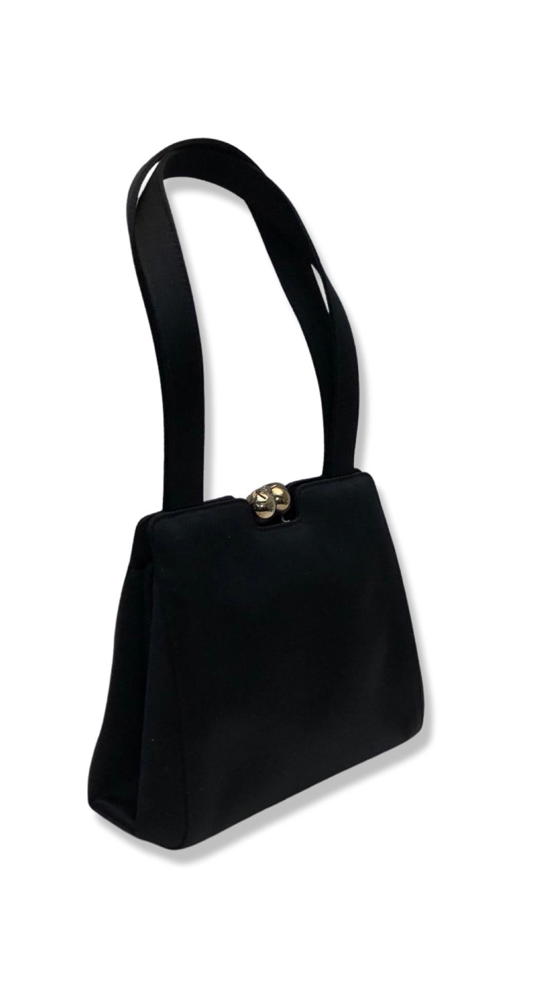 - Vintage 90s Chanel black silk purse handbag.

- Silver CC hardware kiss lock closure.

- Leather interior. 

- One interior zip closure pocket. One interior slip pocket.

- Condition: Please note this vintage item is not new, so it might have